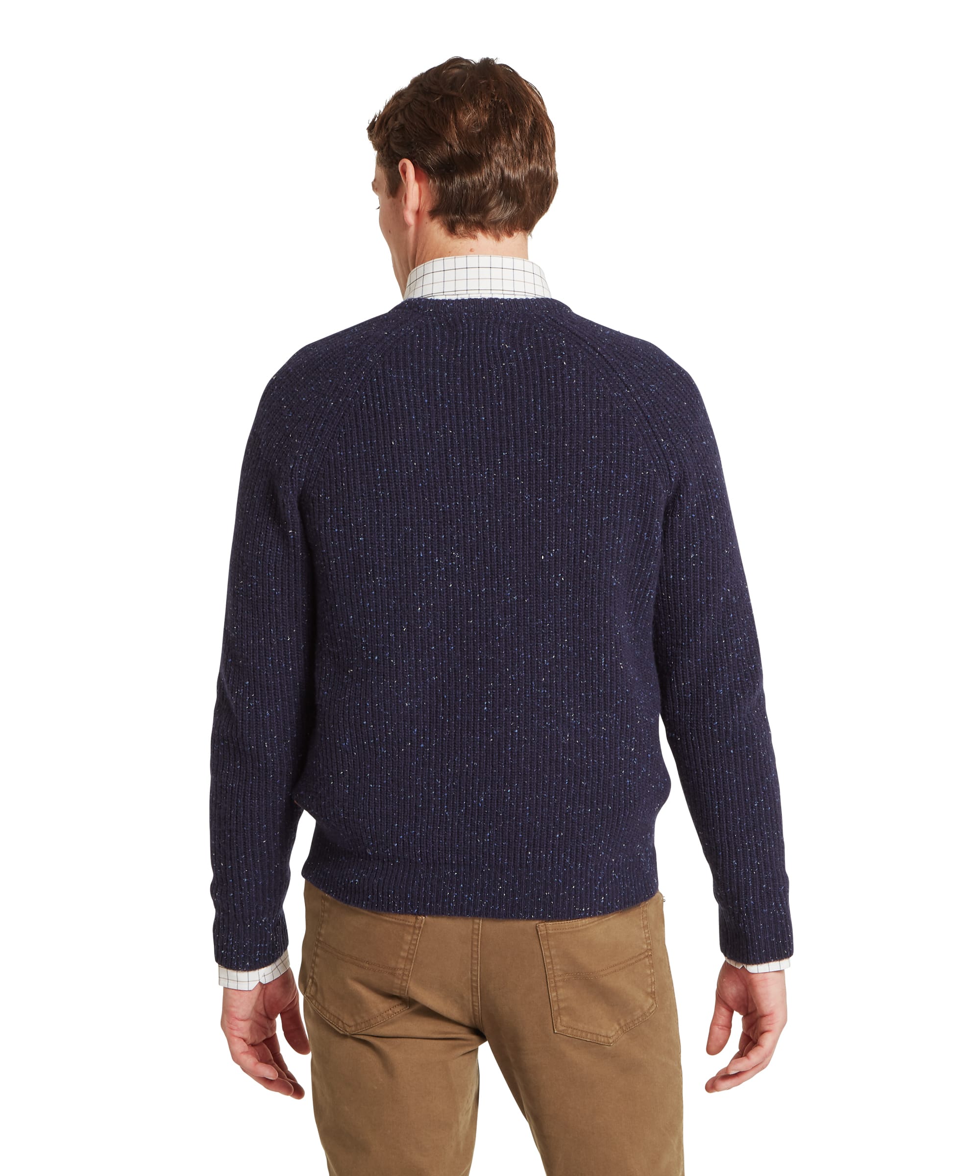 Schöffel Men's Balmaha Crew Neck Jumper in Blue - rear view showing the ribbed back panel, raglan shoulder seams, and navy donegal fleck of the lambswool crew neck jumper, worn over a check shirt with khaki trousers.