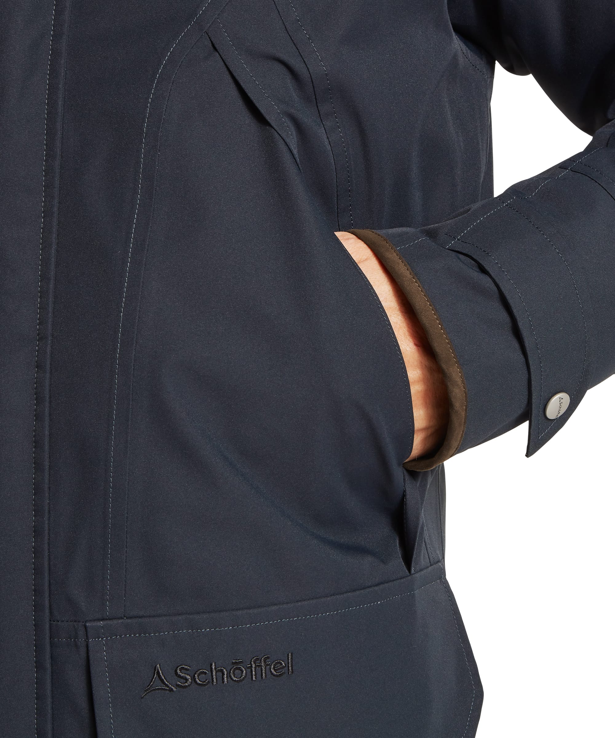 Schöffel Men's Barrow Country Coat in Navy - side profile view showing the straight mid-length cut, press-stud flap side pocket, and adjustable wax cotton cuffs, worn with jeans.