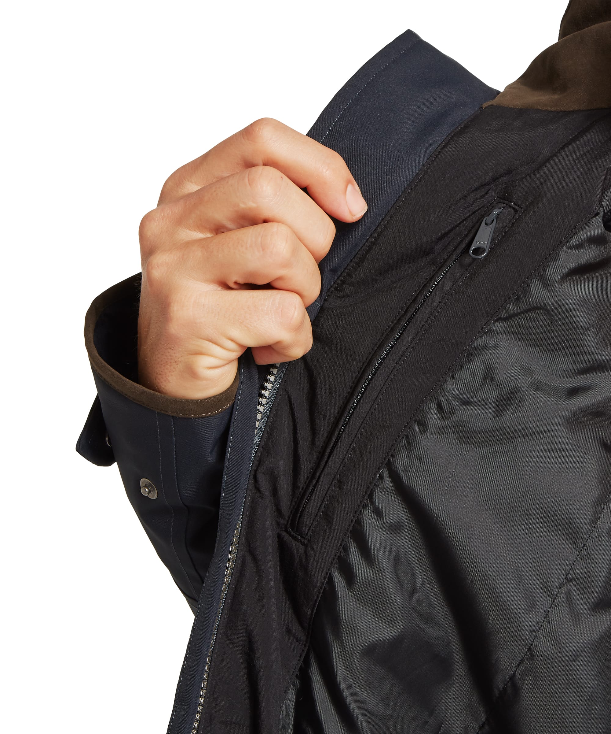 Detail shot of the Schöffel Men's Barrow Country Coat in Navy, showing the side hand-warmer pocket with suede-trim opening and Schöffel embroidered branding on the lower hem, with wax cotton inner cuff detail.