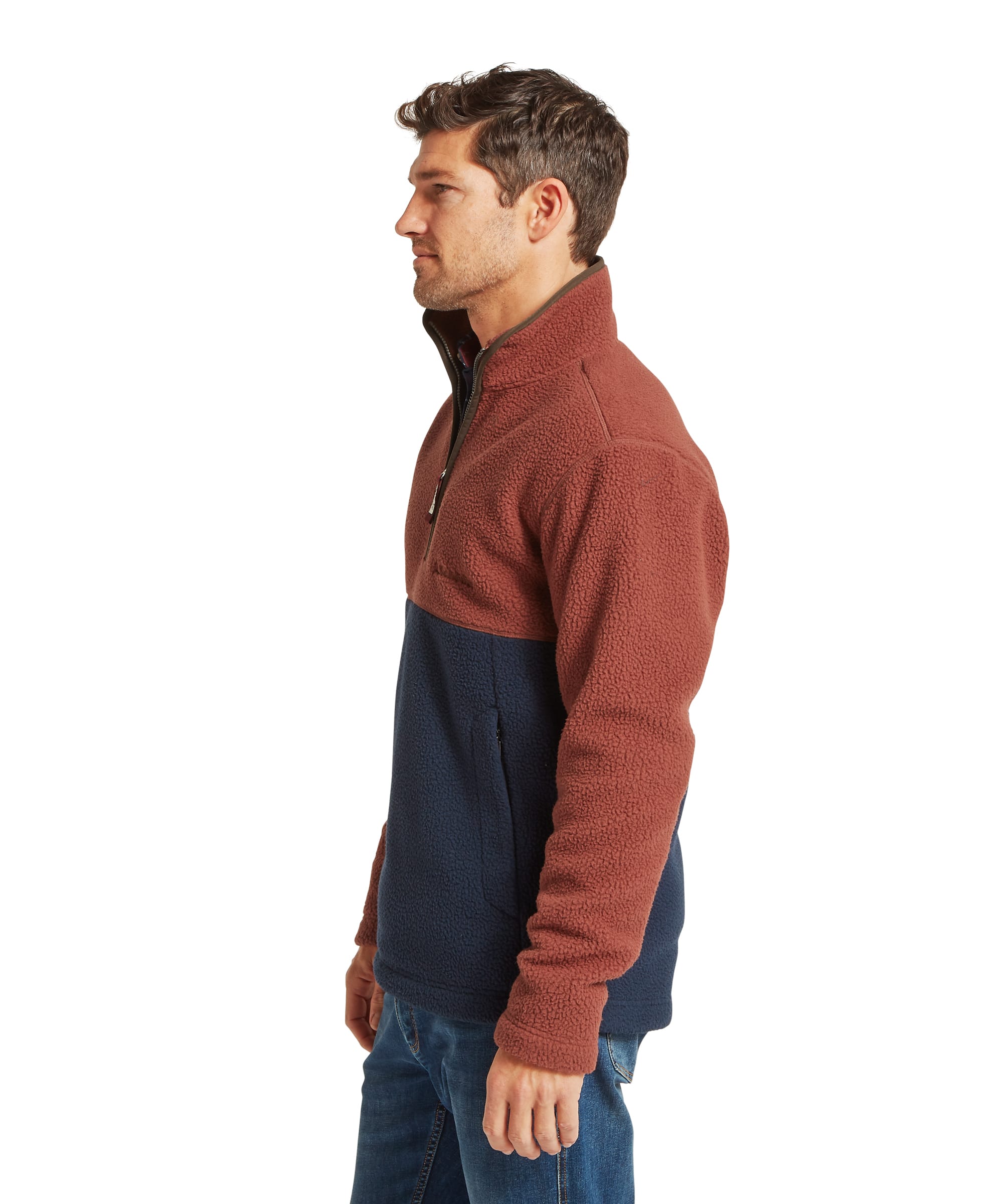 Schöffel Men's Berkeley Retro Fleece in Brown - side profile view showing the relaxed fit and colour-block panelling of the rust and navy sherpa fleece, with the funnel collar and quarter-zip detail visible, worn with jeans.
