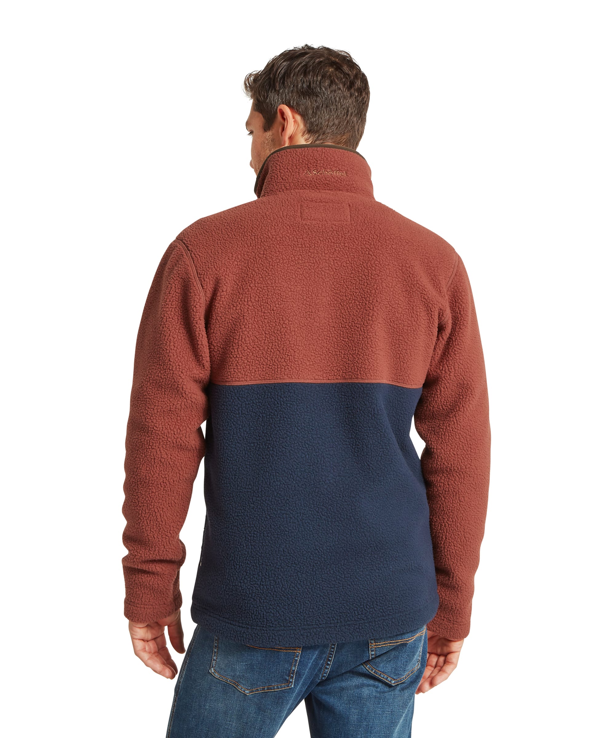 Schöffel Men's Berkeley Retro Fleece in Brown - rear view showing the rust upper back and navy lower panel of the colour-block sherpa quarter-zip fleece with Schöffel logo embroidered at the back collar, worn with jeans.