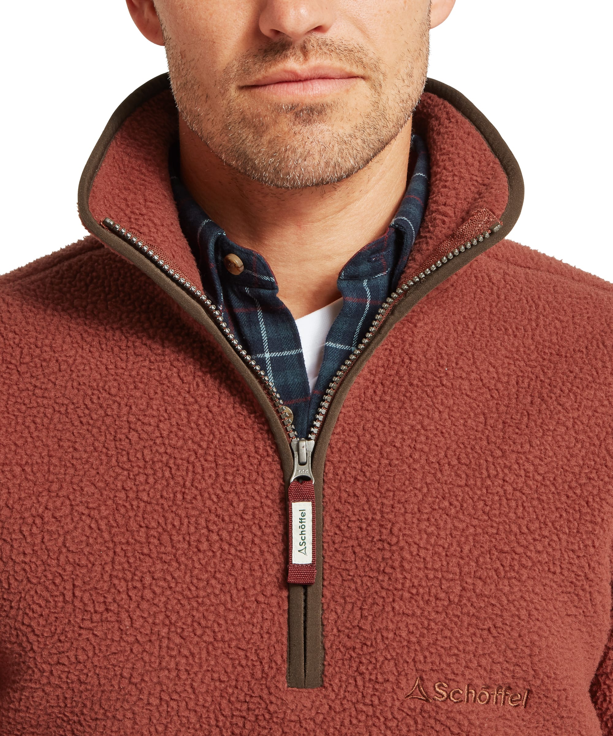 Close-up collar and quarter-zip detail of the Schöffel Men's Berkeley Retro Fleece in Brown, showing the rust sherpa funnel neck with dark brown contrast trim, chunky zip with Schöffel branded pull, and a layered check shirt collar beneath.