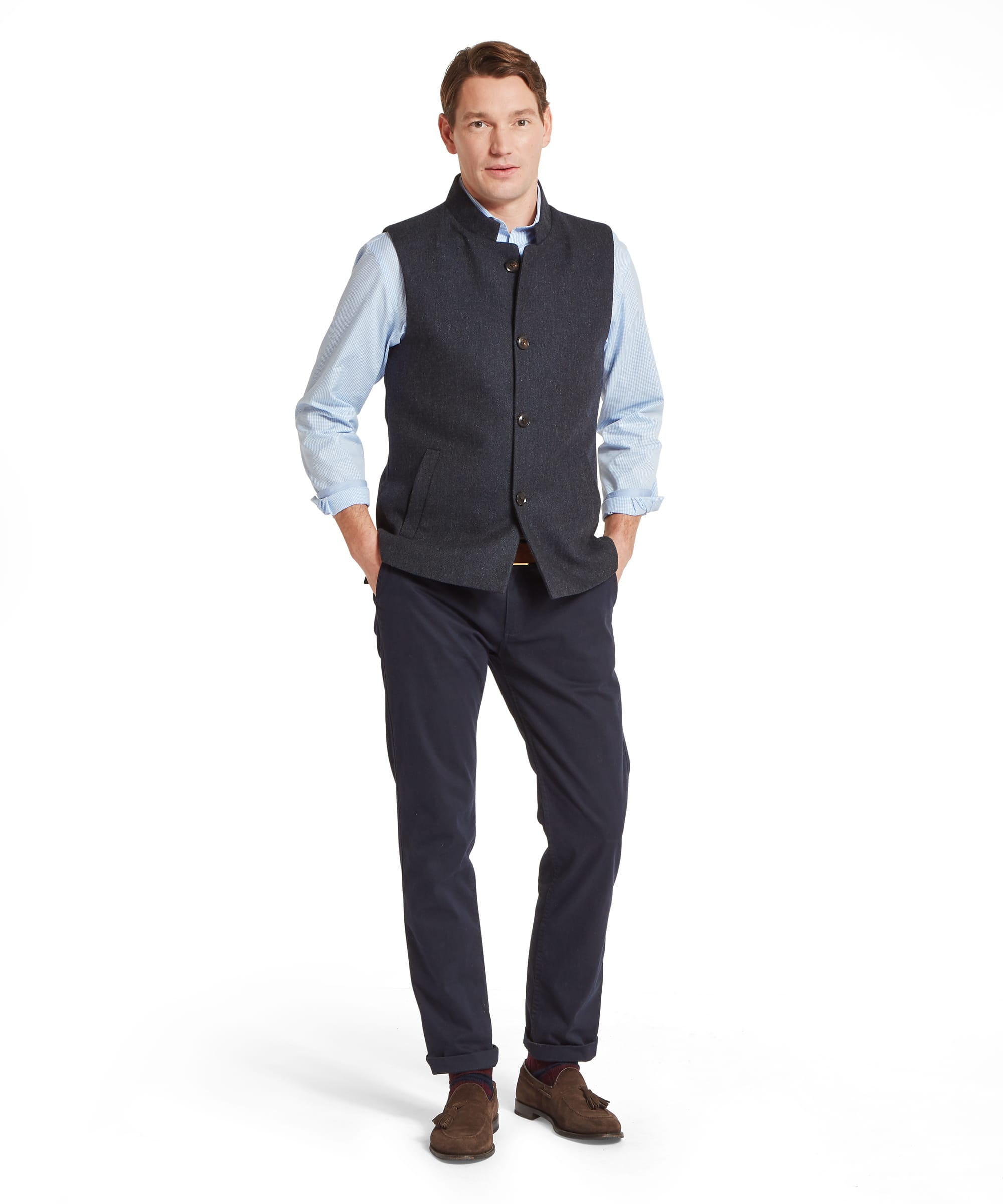 Schöffel Men's Berwick Nehru Tweed Waistcoat in Navy - full-length front view showcasing the tailored fit and classic country styling, worn over a blue check shirt with navy trousers, a tan belt, and brown suede tassel loafers.