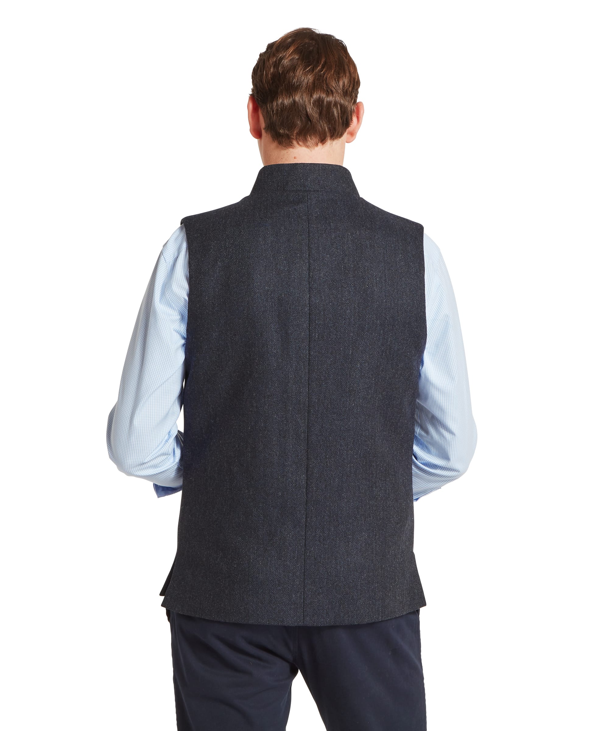 Schöffel Men's Berwick Nehru Tweed Waistcoat in Navy - three-quarter side view showing the tailored cut, button fastening, and welt side pocket of the navy Lovat Tweed waistcoat, worn with a blue check shirt and navy trousers.