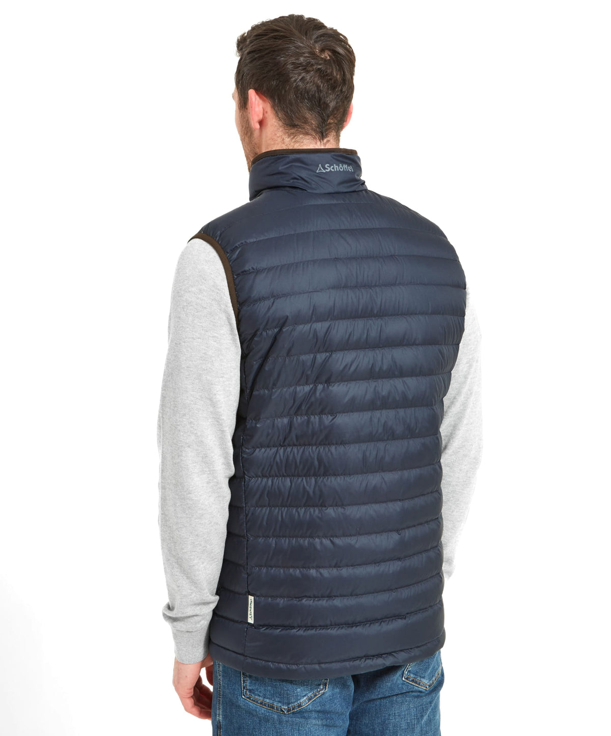 Navy blue quilted Bowden Down Gilet puffer vest with high collar and brown trim made for warmth and style