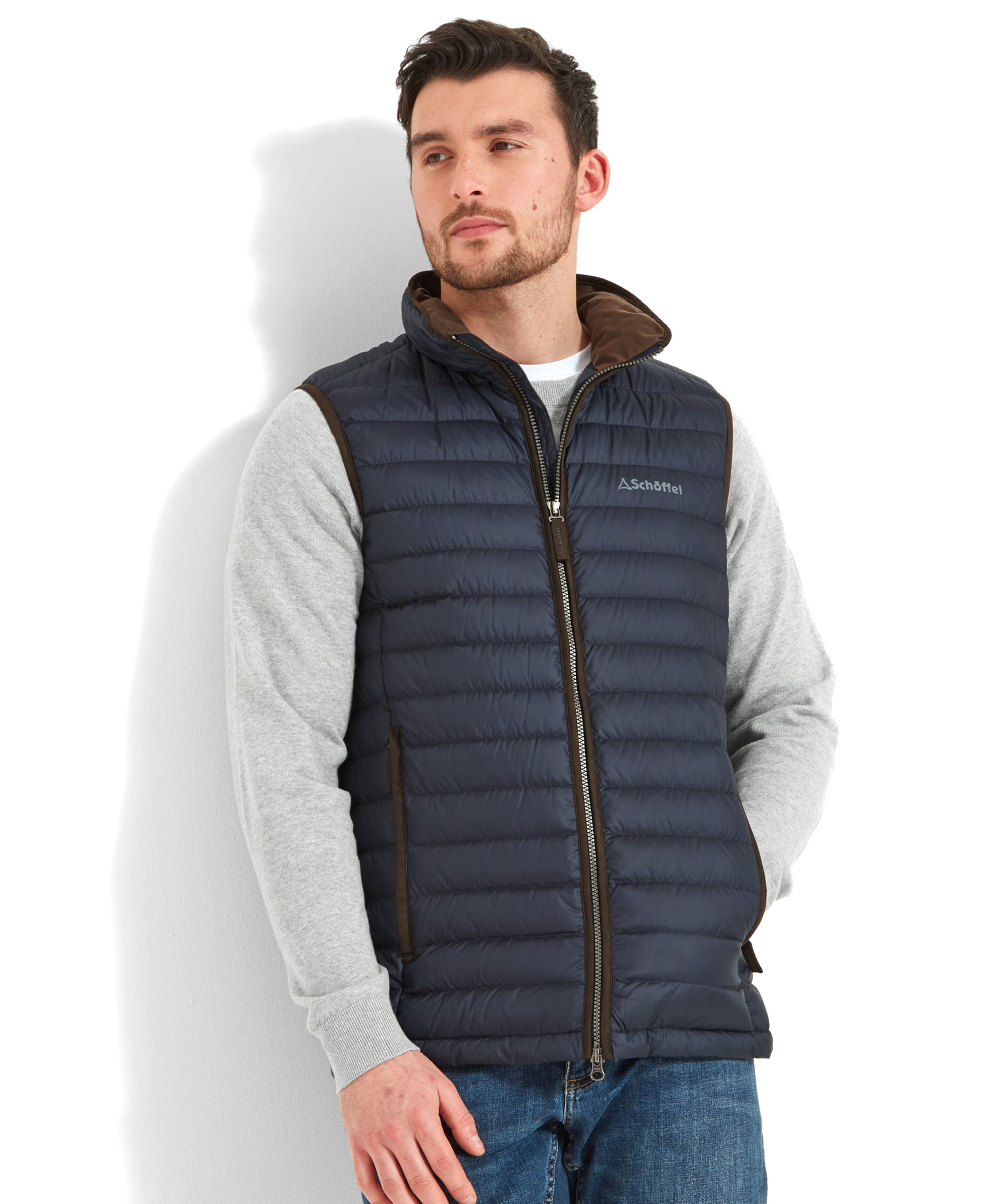 Navy blue quilted down gilet with brown trim and zipper pull designed for warmth and lightweight comfort