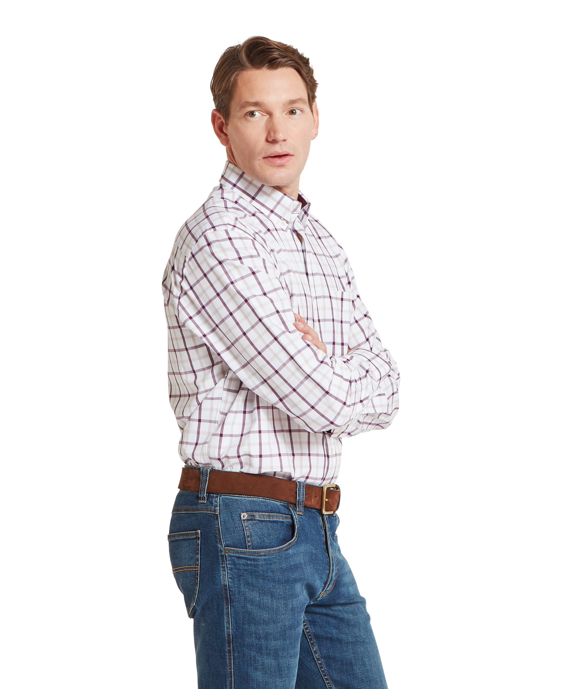 Schöffel Men's Brancaster Classic Shirt in Red - side profile view showing the relaxed classic fit and bold burgundy windowpane check pattern, worn tucked into blue jeans with a tan leather belt.