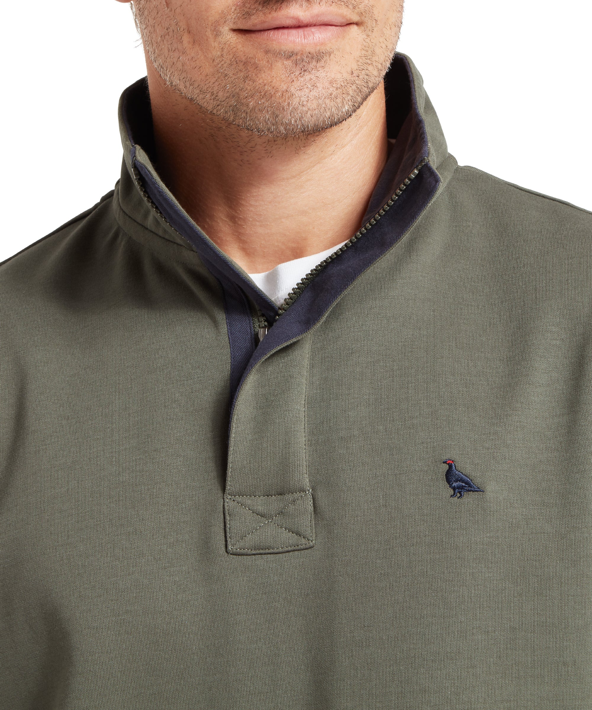 Close‑up of an olive quarter‑zip pullover with the collar turned up to show the dark inner lining and a white undershirt, featuring a small embroidered ptarmigan bird logo on the left chest.
