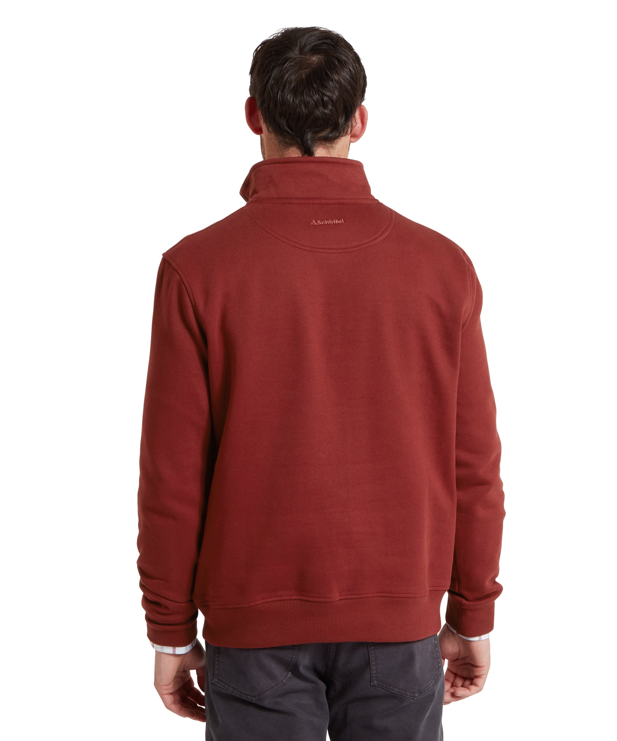 Man wearing a red sweatshirt with a visible brand logo on the back, standing against a white background.