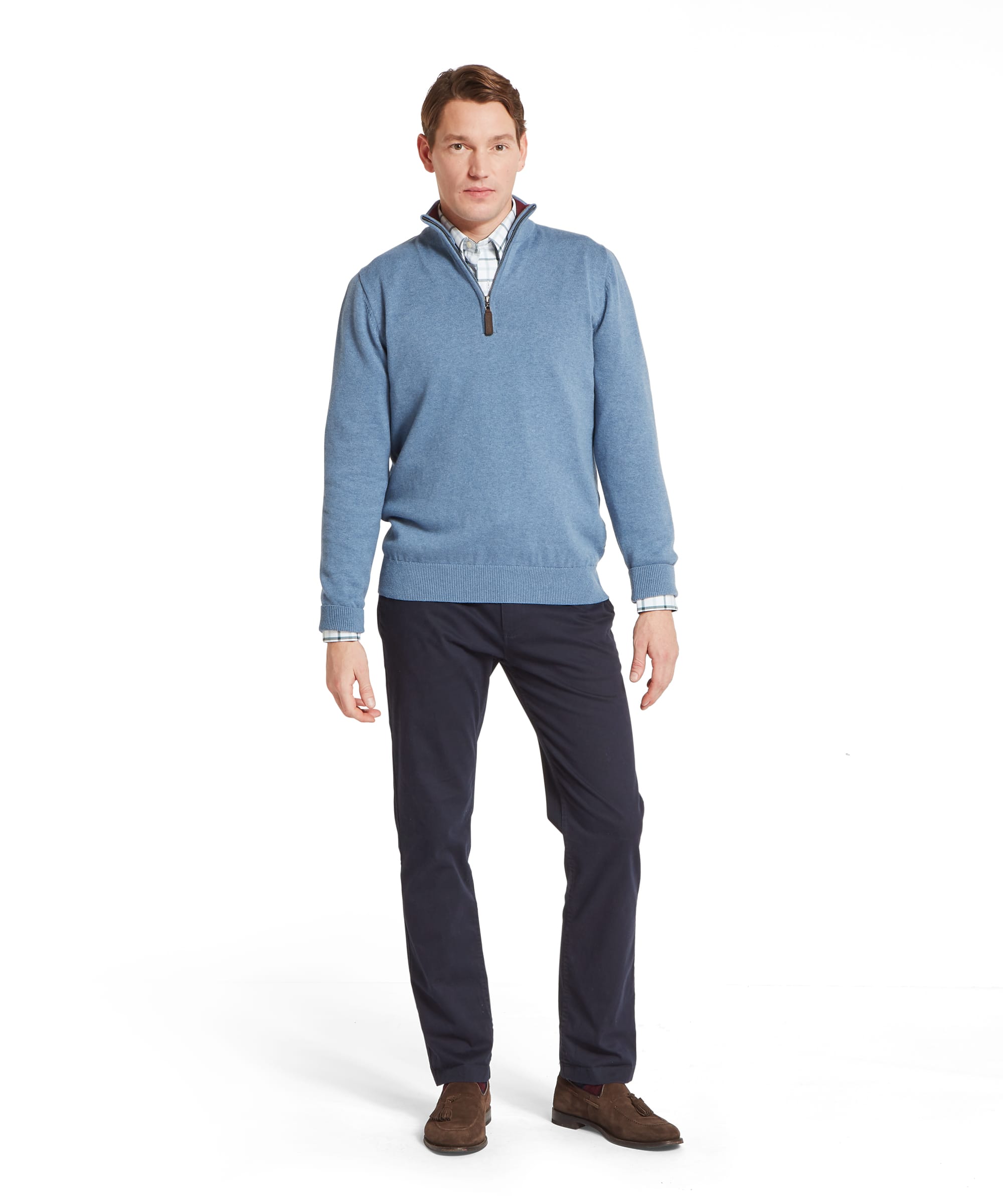 Schöffel Men's Calton Cotton Cashmere Quarter Zip Jumper in Blue - full-length front view of the denim-blue marl cotton-cashmere quarter-zip worn over a check shirt with navy chinos and brown suede tassel loafers.