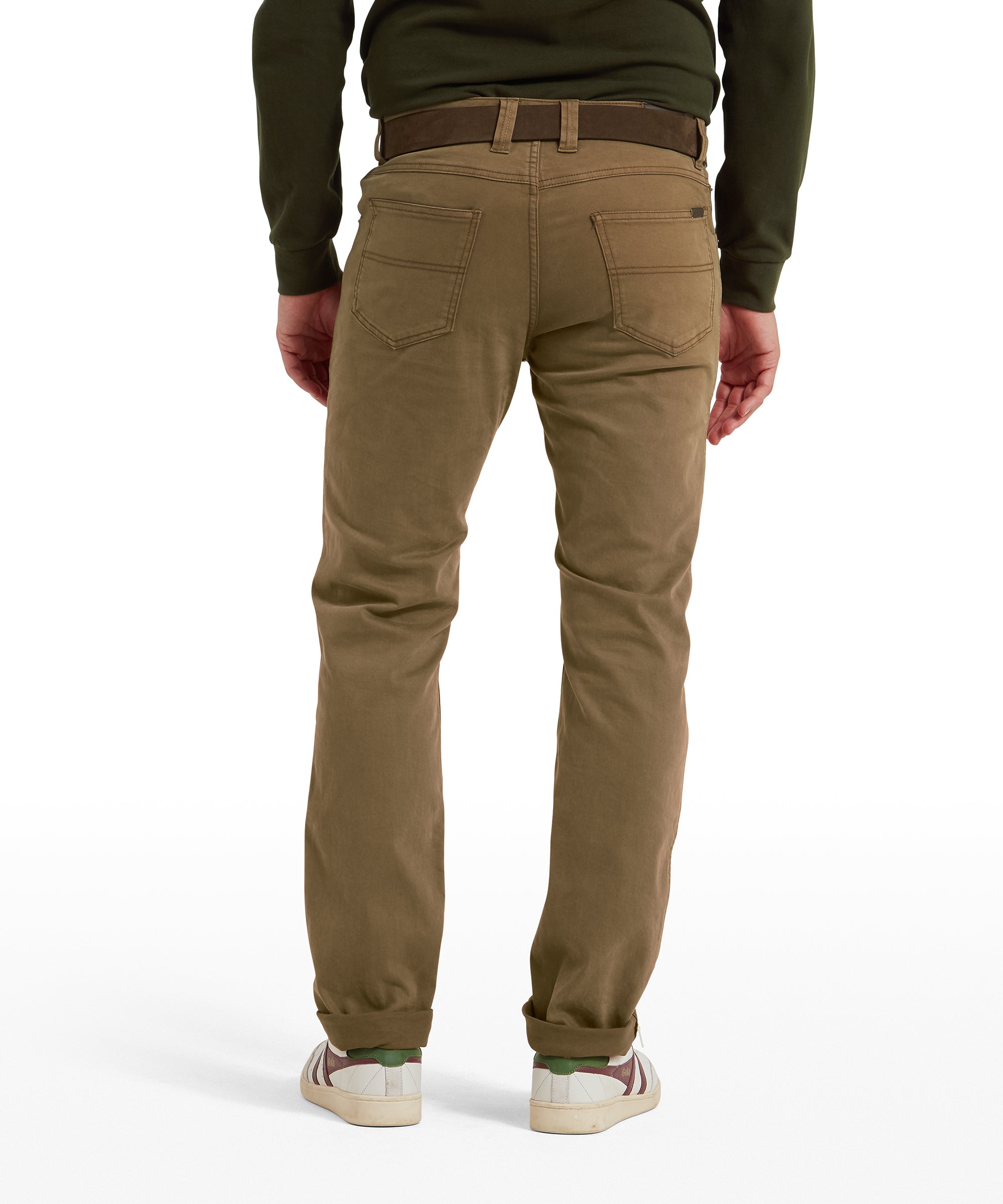 Person facing backwards  wearing brown jeans against a white background