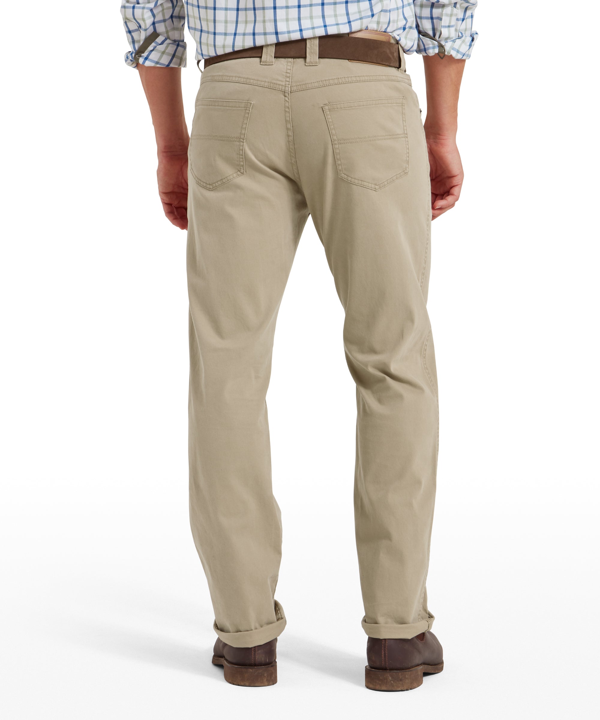 Rear view of a man wearing a blue and white check shirt with rolled-up sleeves, camel-coloured jeans, brown belt and brown shoes. Jeans feature stitched back pockets and are worn full length. Pose shown on a transparent background