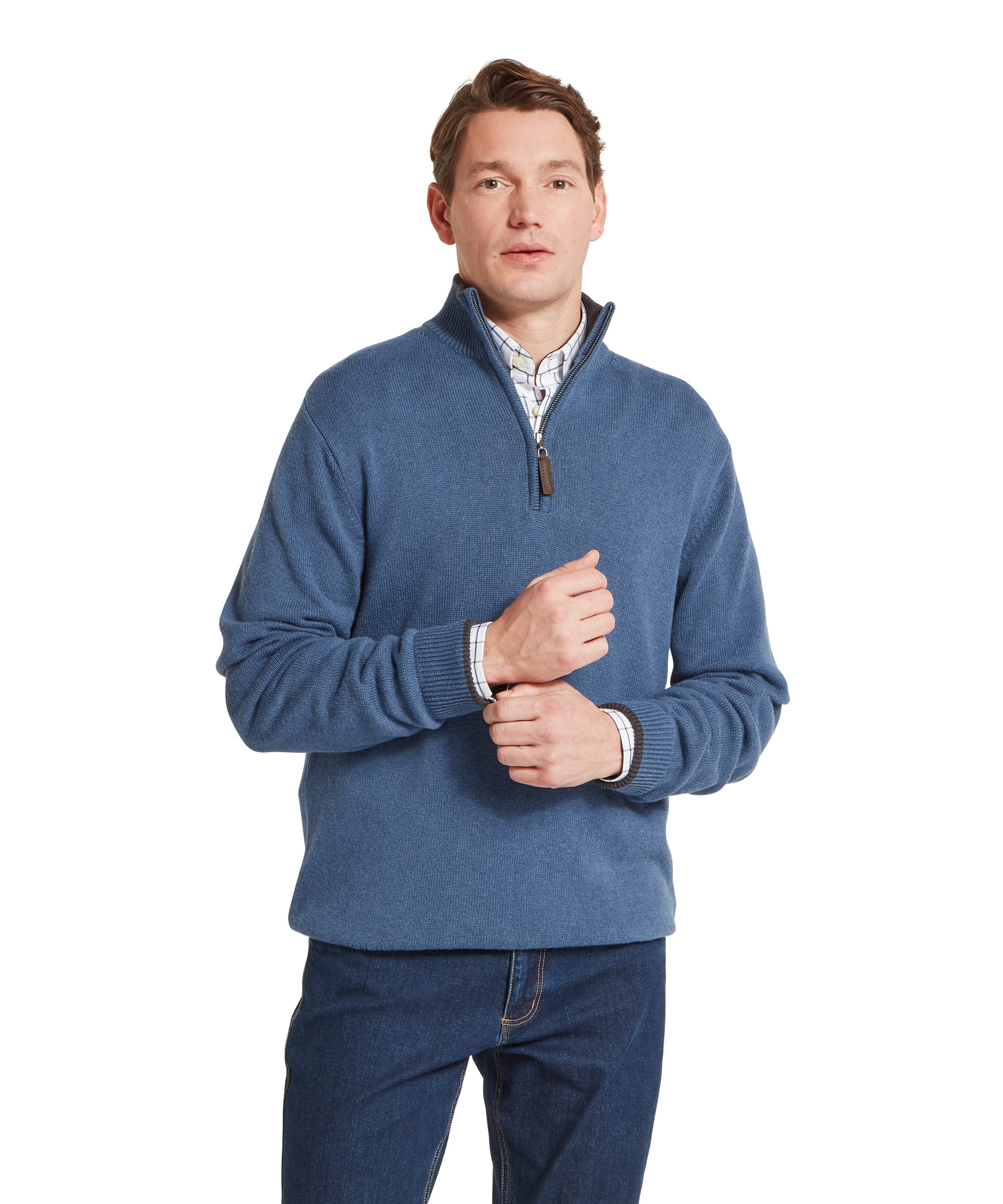 Schöffel Men's Castlebay 1/4 Zip Jumper in Blue — front view showing ribbed quarter-zip collar with leather-tipped pull tab, layered over a check shirt with dark jeans