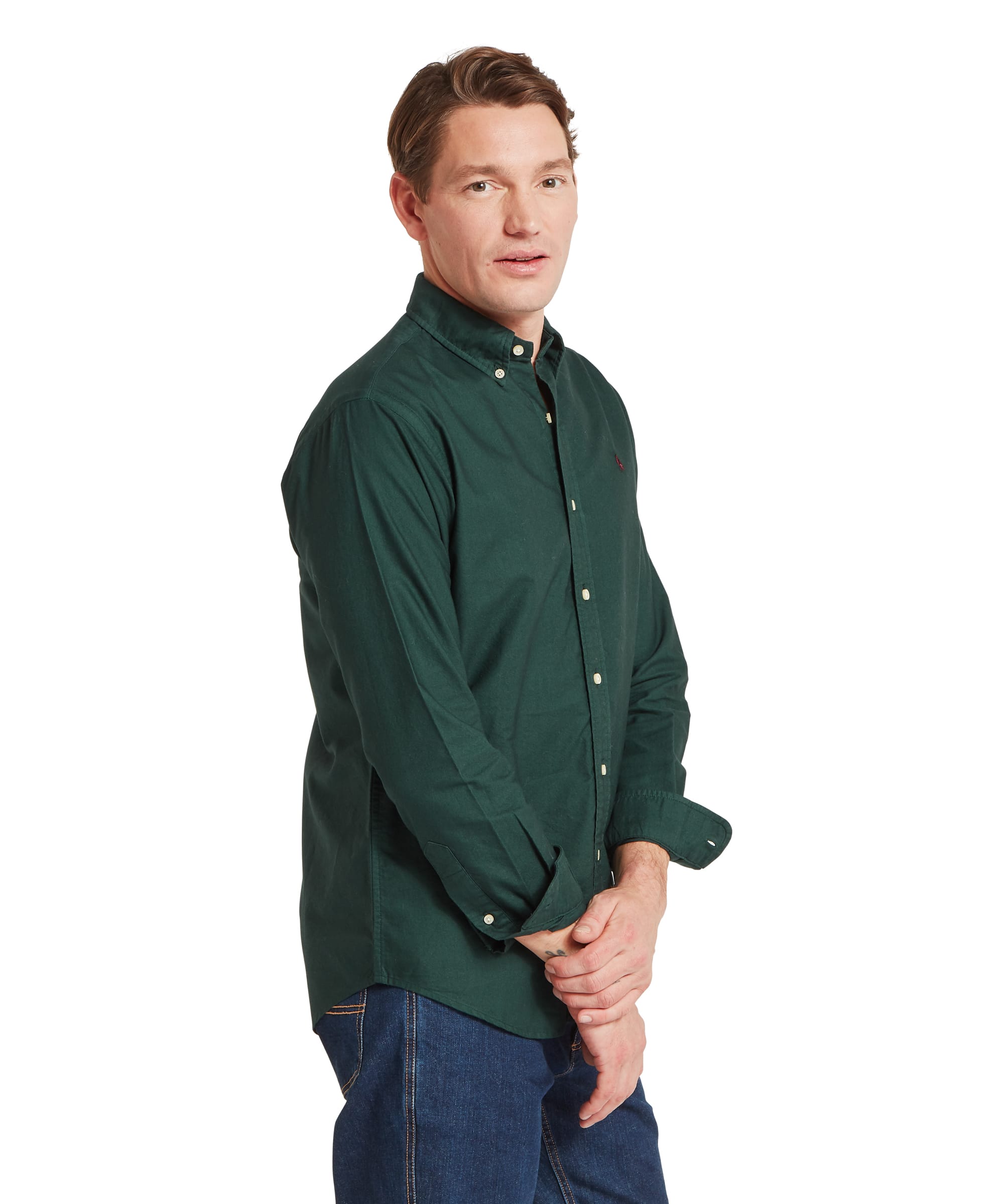 Schöffel Men's Cavendish Oxford Shirt in Green — three-quarter side view showing button-down collar, embroidered grouse logo and relaxed oxford weave, paired with dark jeans