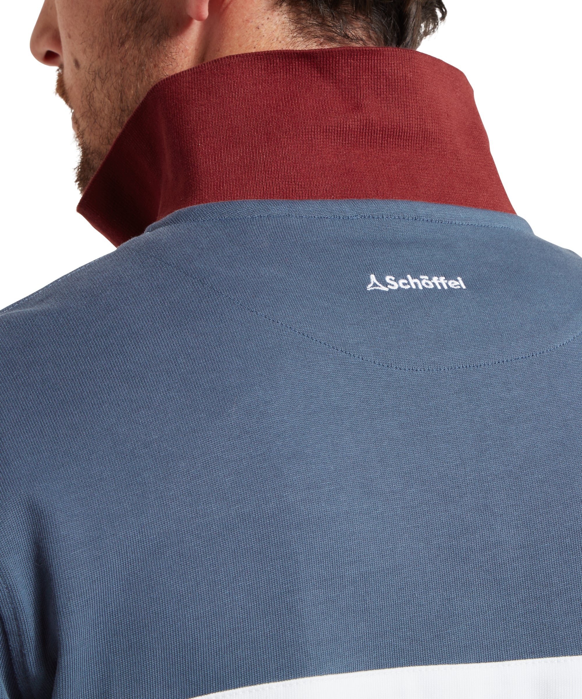 Blue shirt with a red collar and Schöffel logo on the back