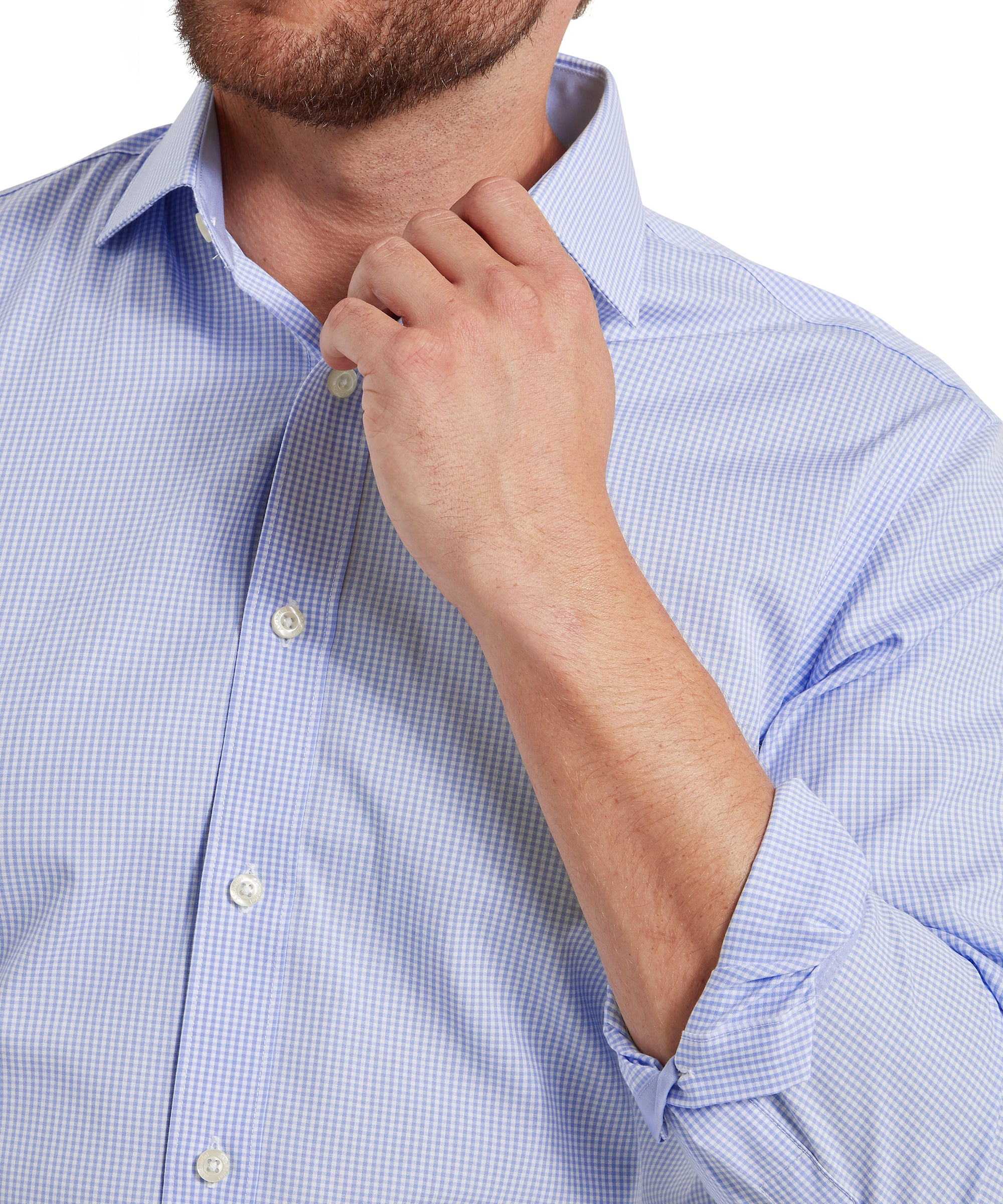 Close-up of a person wearing a light blue checkered shirt with rolled-up sleeves.