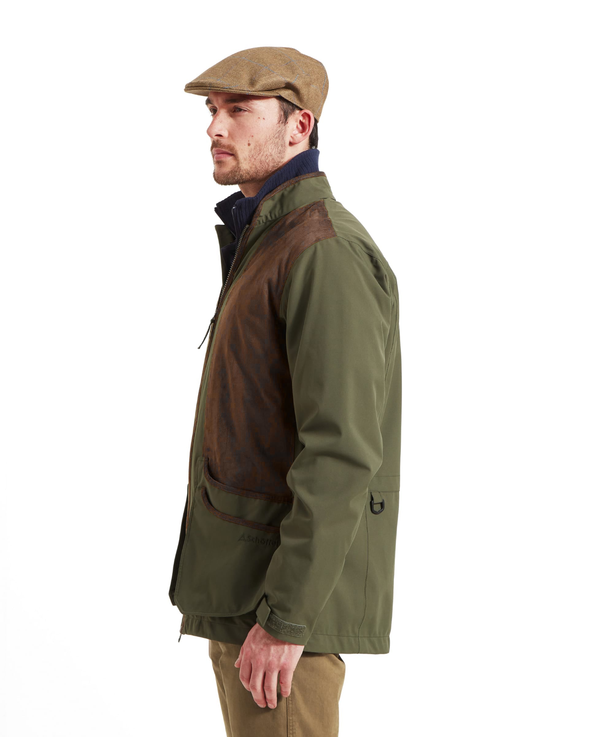 Man wearing the Schöffel Grimsthorpe Clay Shooting Jacket in Green with a tweed flat cap, side view showing the leather-look shoulder patch.