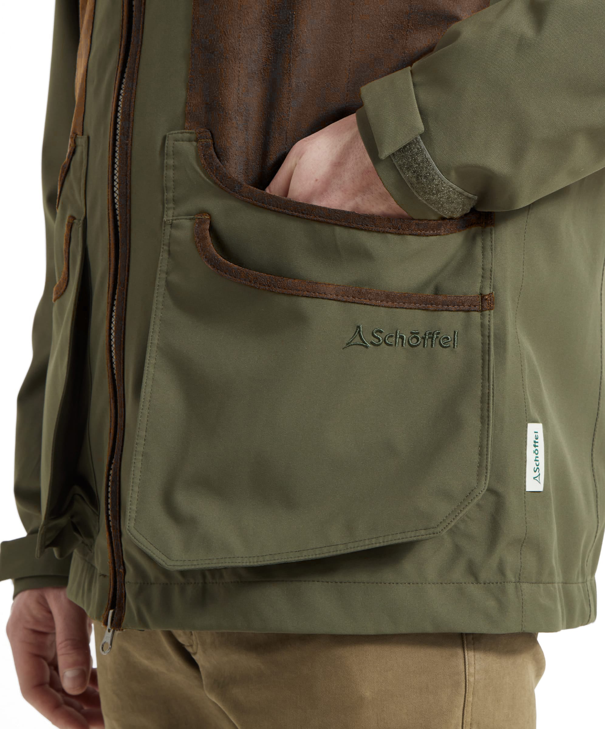 Close-up of the Schöffel Grimsthorpe Clay Shooting Jacket in Green, showing the reinforced cartridge pocket and embroidered branding.