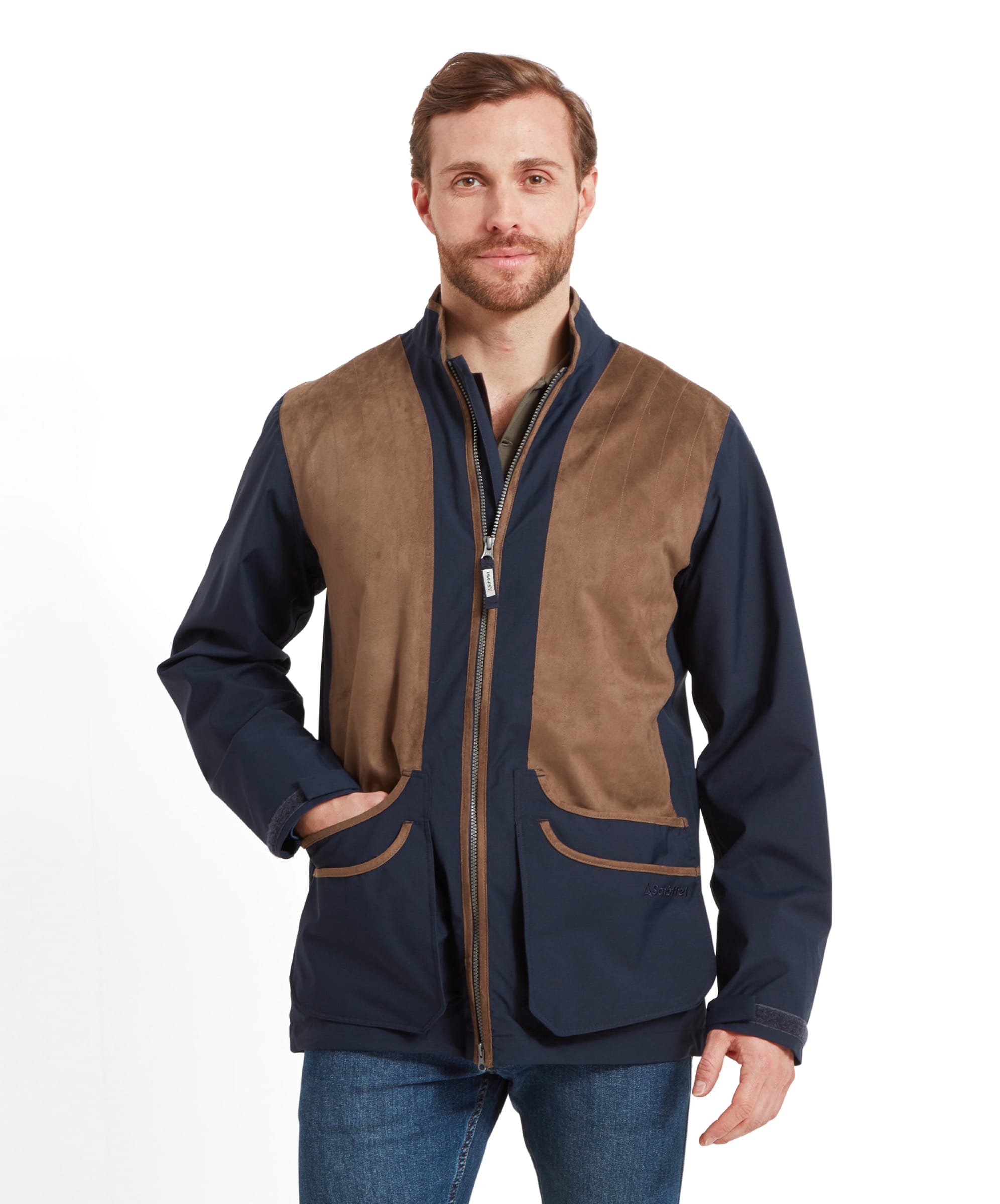 Schöffel Men's Grimsthorpe Clay Shooting Jacket in Blue — front view showing suede shooting patches, full-length zip, cartridge pockets with suede trim and Schöffel branding, styled with dark jeans