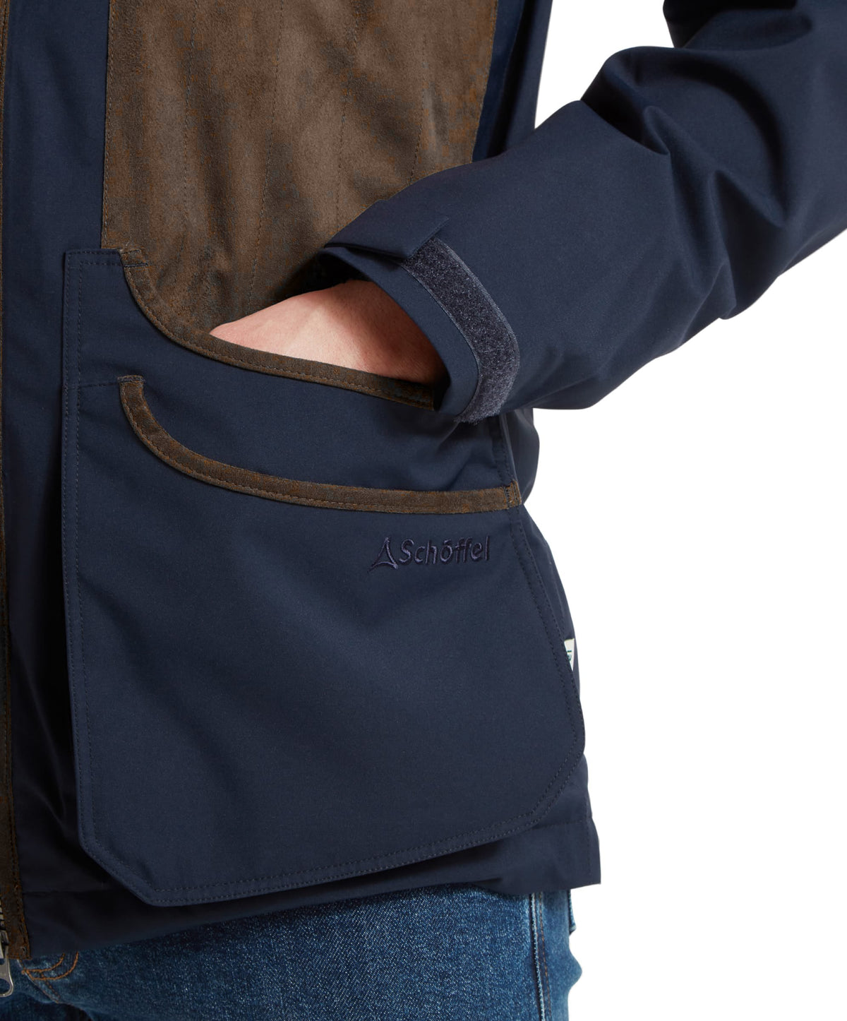 Schöffel's Grimsthorpe Clay Shooting Jacket in Blue, on model, schöffel logo on pocket