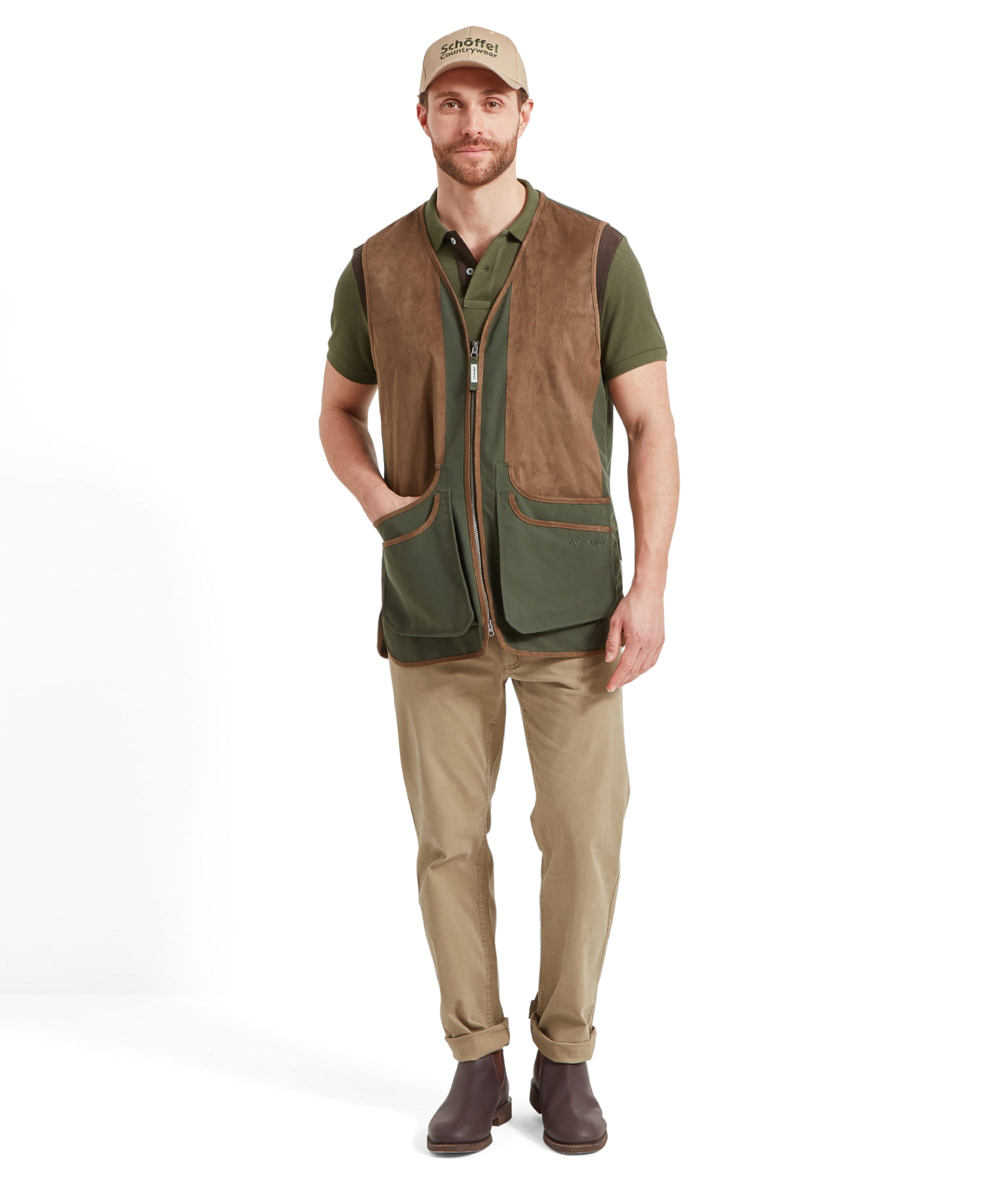 Schöffel Men's Grimsthorpe Clay Shooting Vest in Green — front view showing contrast suede shooting patches, deep cartridge pockets with suede trim and Schöffel branded zip, layered over a polo shirt with a Schöffel Countrywear cap