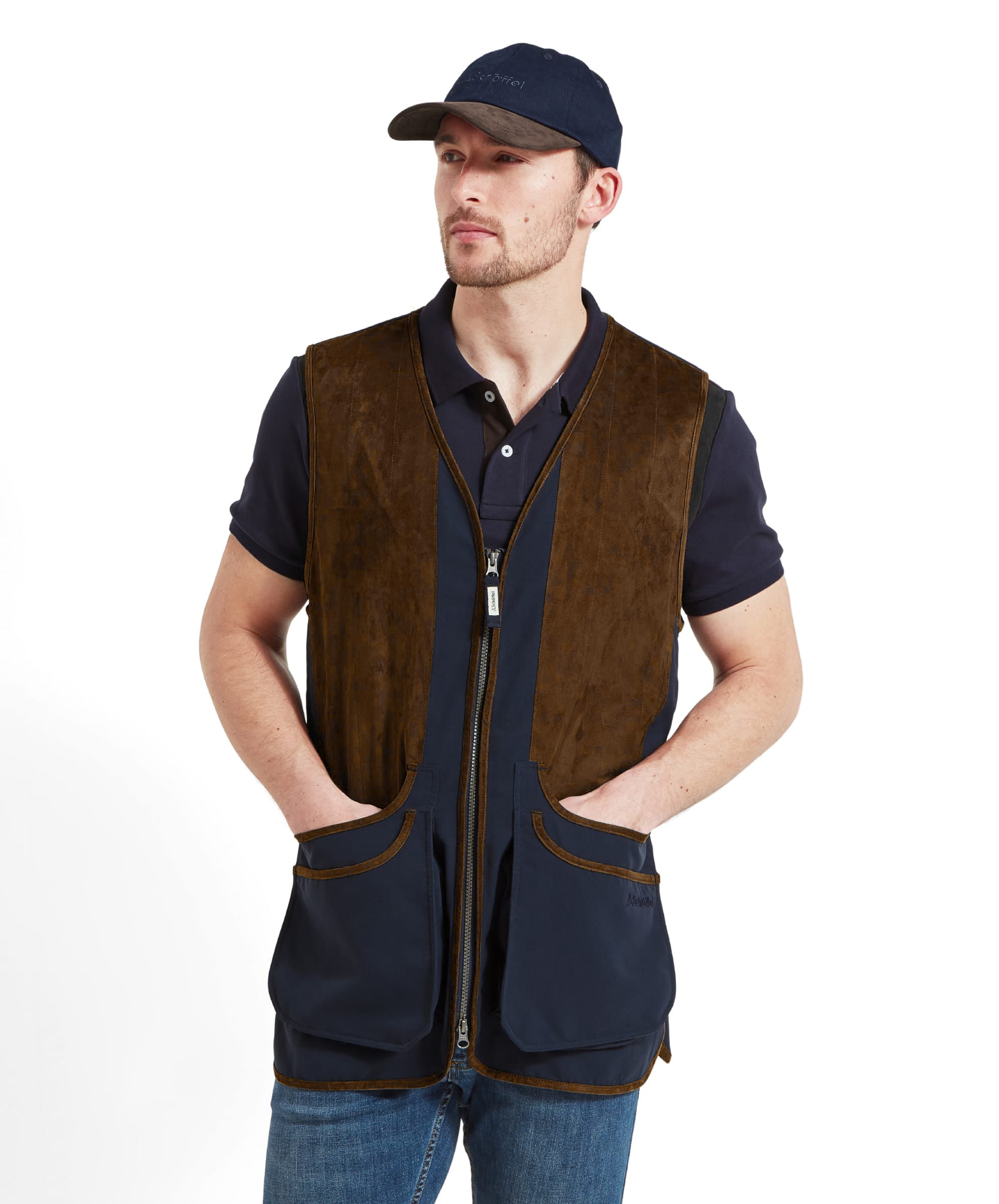 Man wearing a navy and brown shooting vest over a navy shirt on a white background