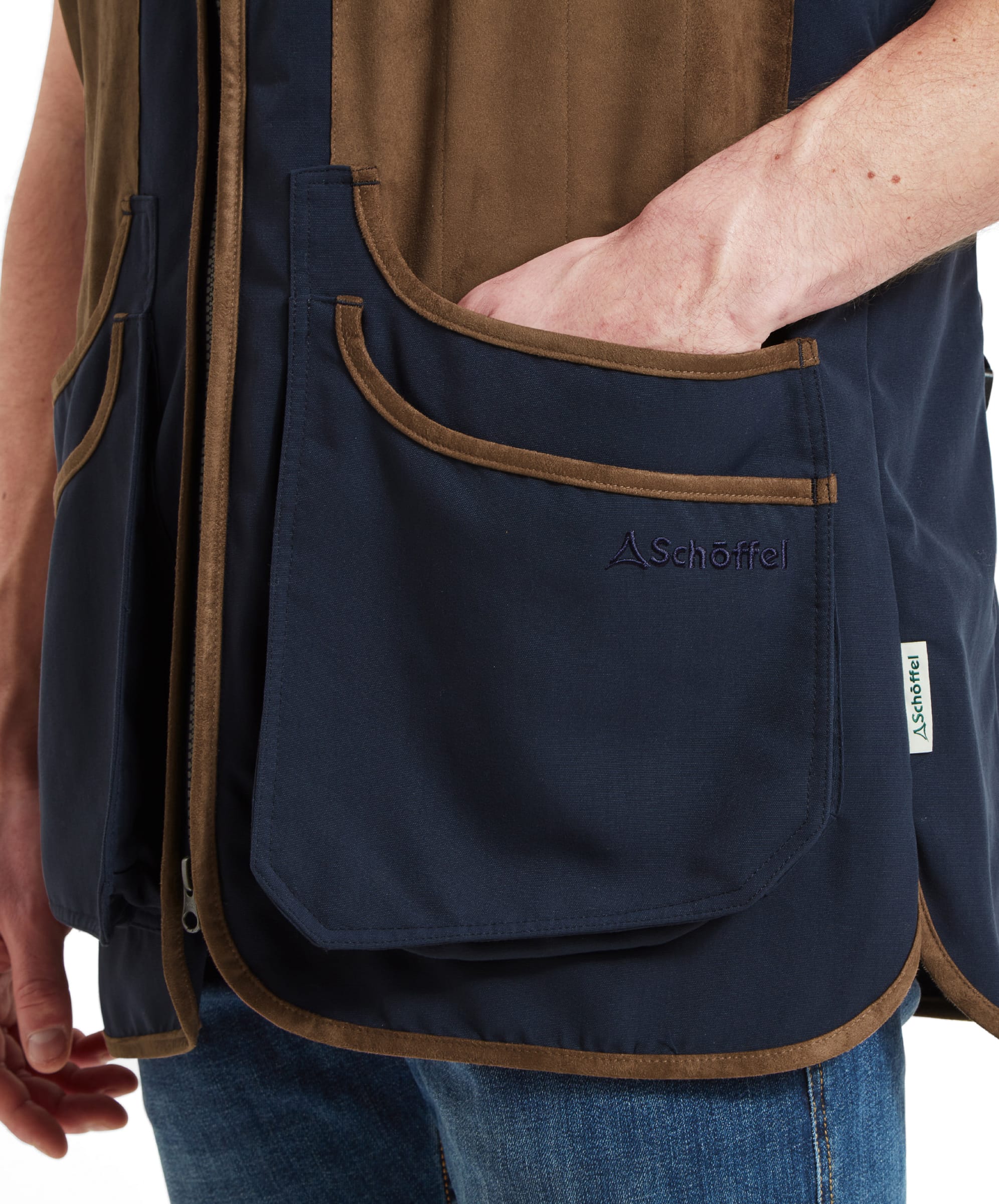 Schöffel Men's Grimsthorpe Clay Shooting Vest in Blue — close-up of deep cartridge pocket showing Schöffel embroidered logo, suede trim edging and woven label