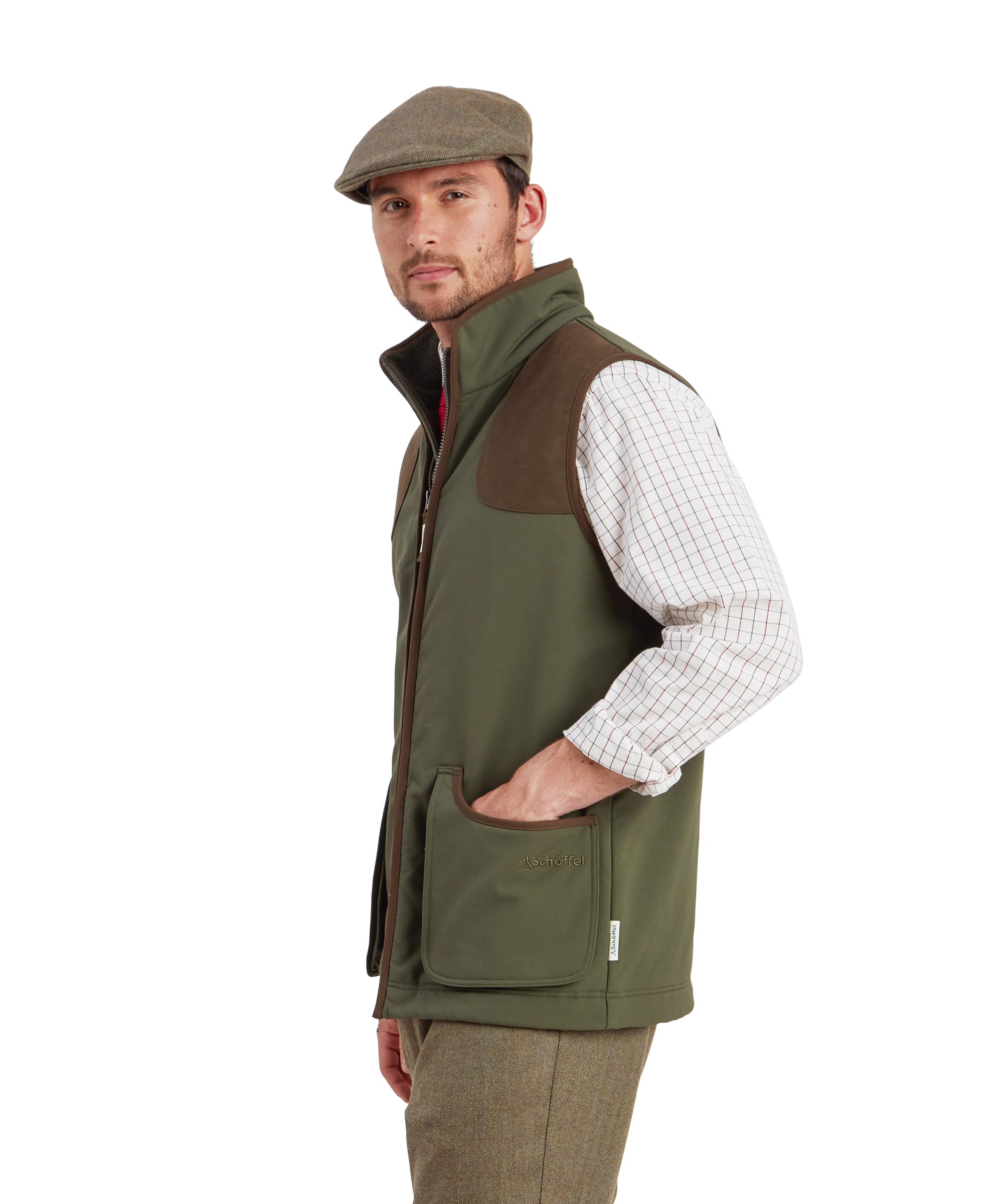 Schöffel Men's Gunby Gilet in Green — three-quarter side view showing suede shoulder patch, stand collar, lower pocket with suede trim and Schöffel branding, worn with a tweed flat cap