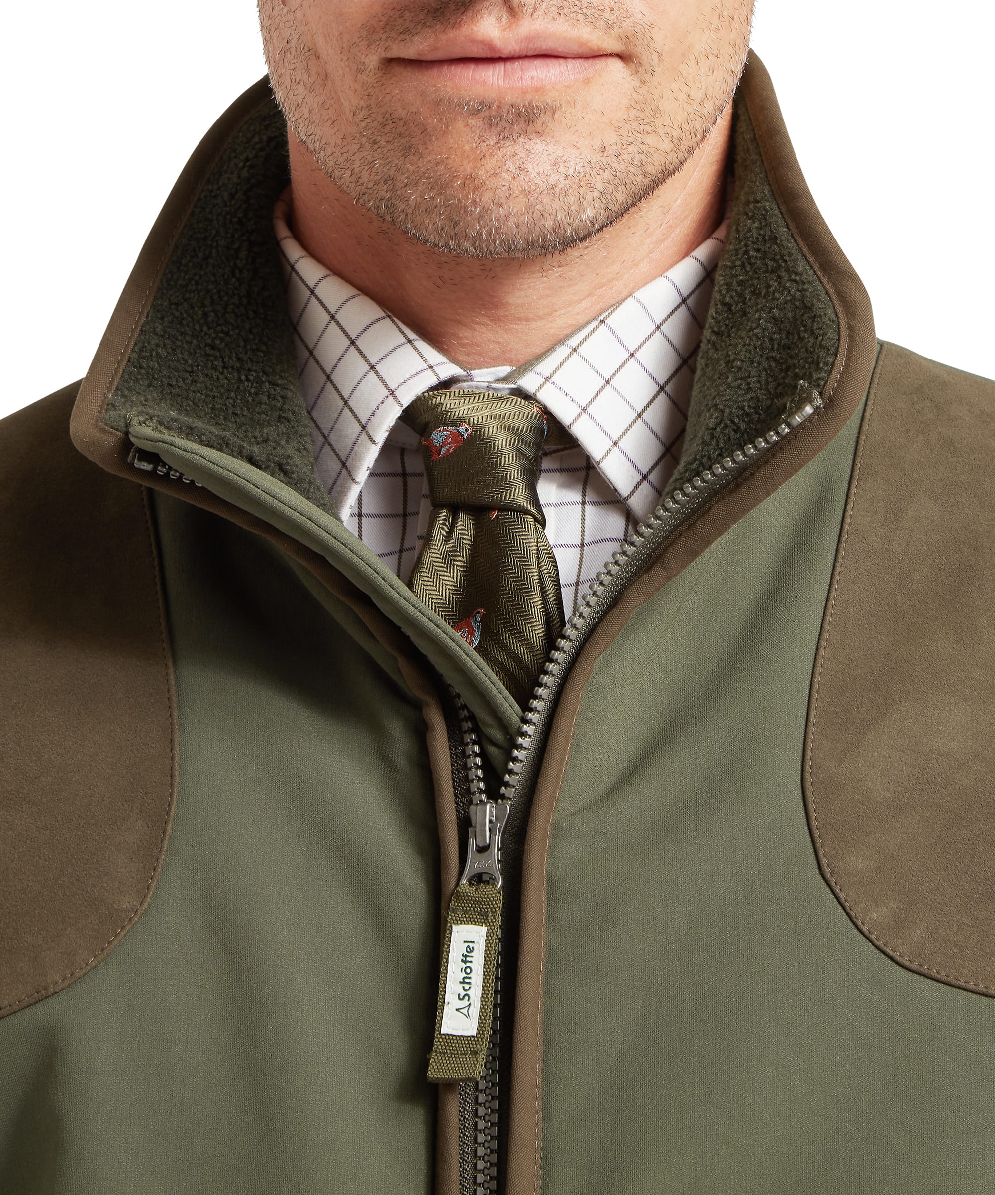 Schöffel Men's Gunby Jacket in Green — close-up of deep lower pocket showing Schöffel embroidered logo, suede trim edging, snap-button cuff and woven label detail