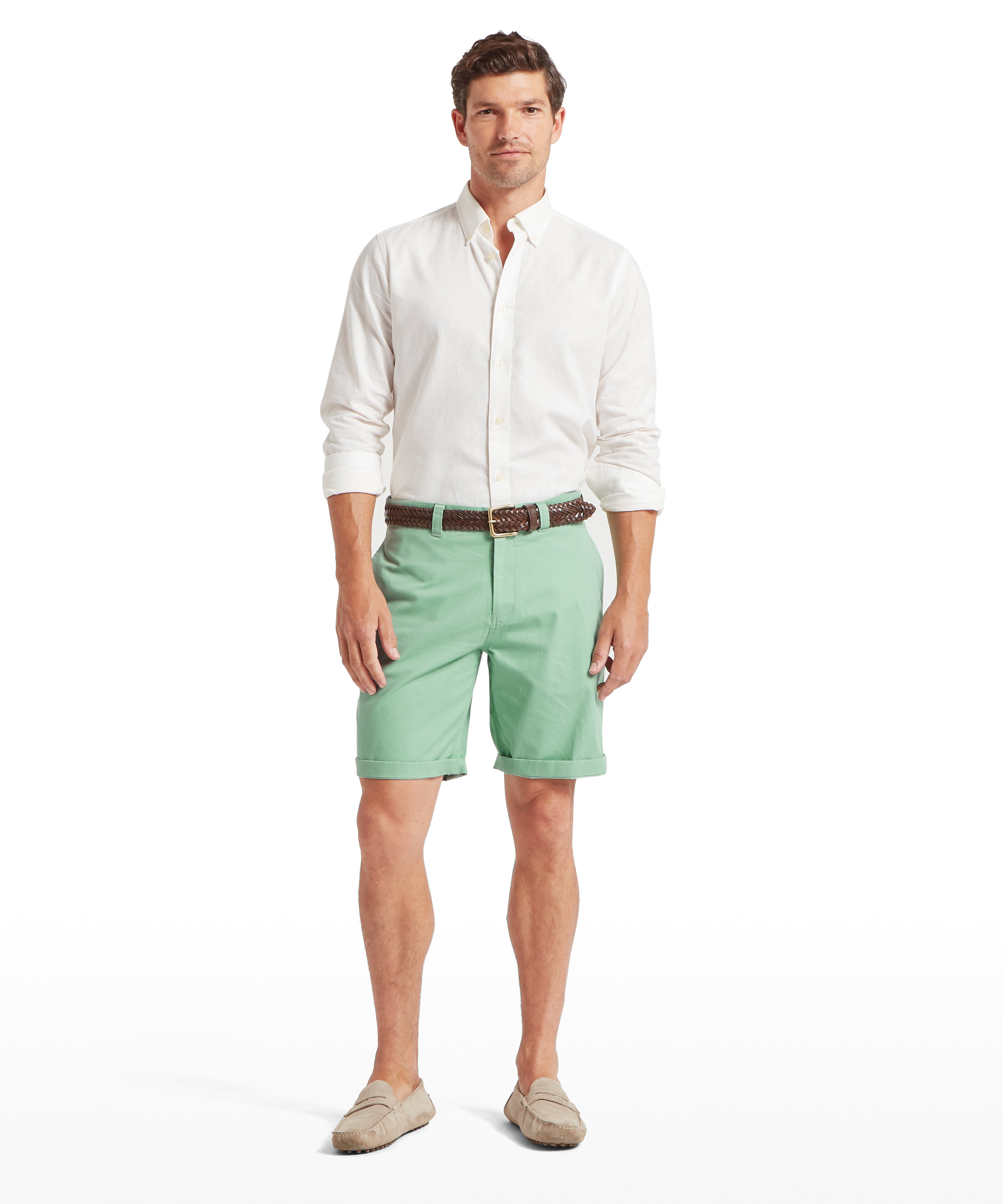 Man wearing a white shirt and aqua green shorts on a white background