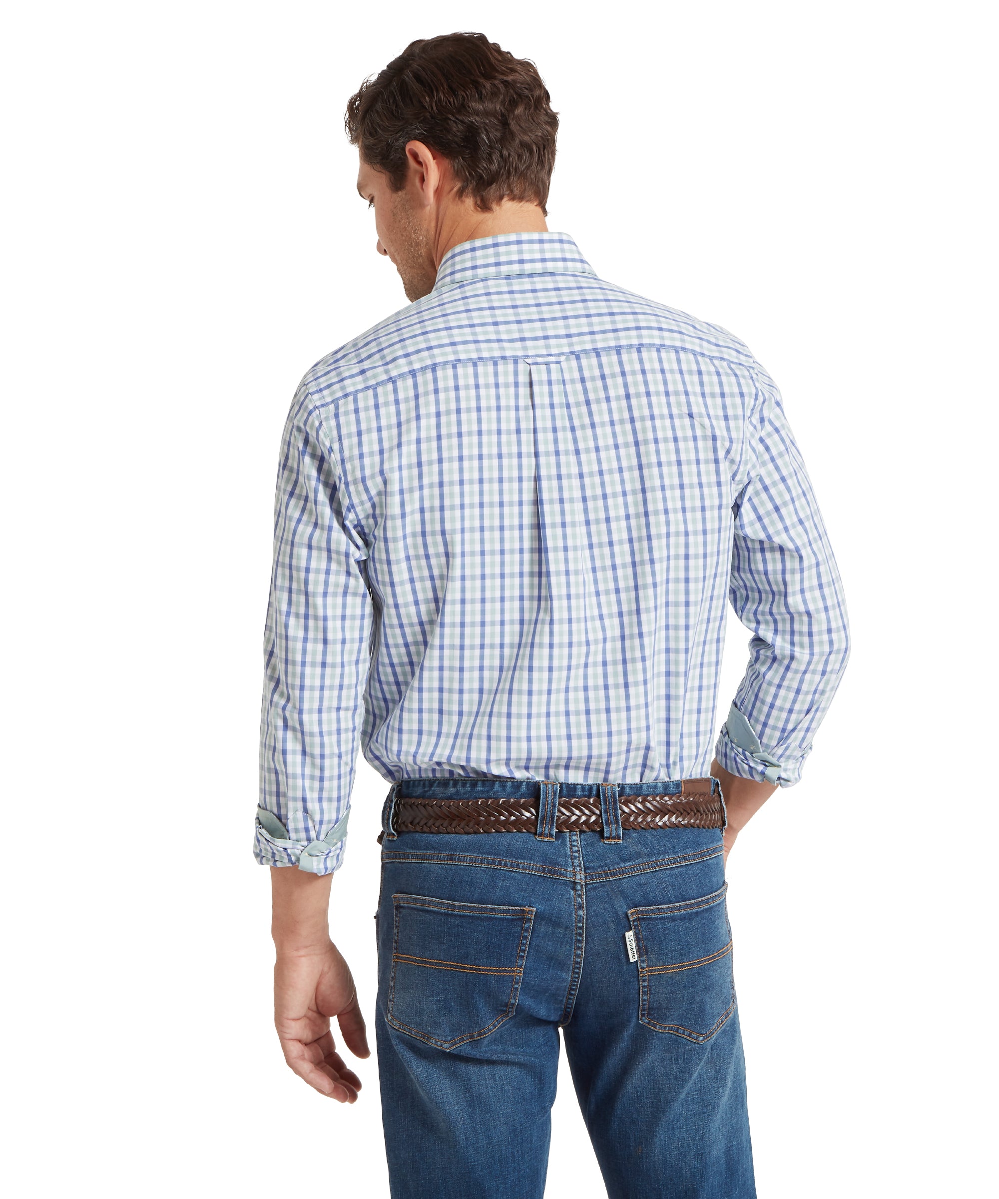 Man viewed from the back, wearing a long-sleeved, button-down shirt with a check pattern in shades of blue, green, and white. The sleeves are rolled up to the forearms, and the shirt is tucked into blue jeans with visible stitching. A brown braided leather belt secures the jeans. The outfit is casual, suitable for everyday or smart-casual occasions.