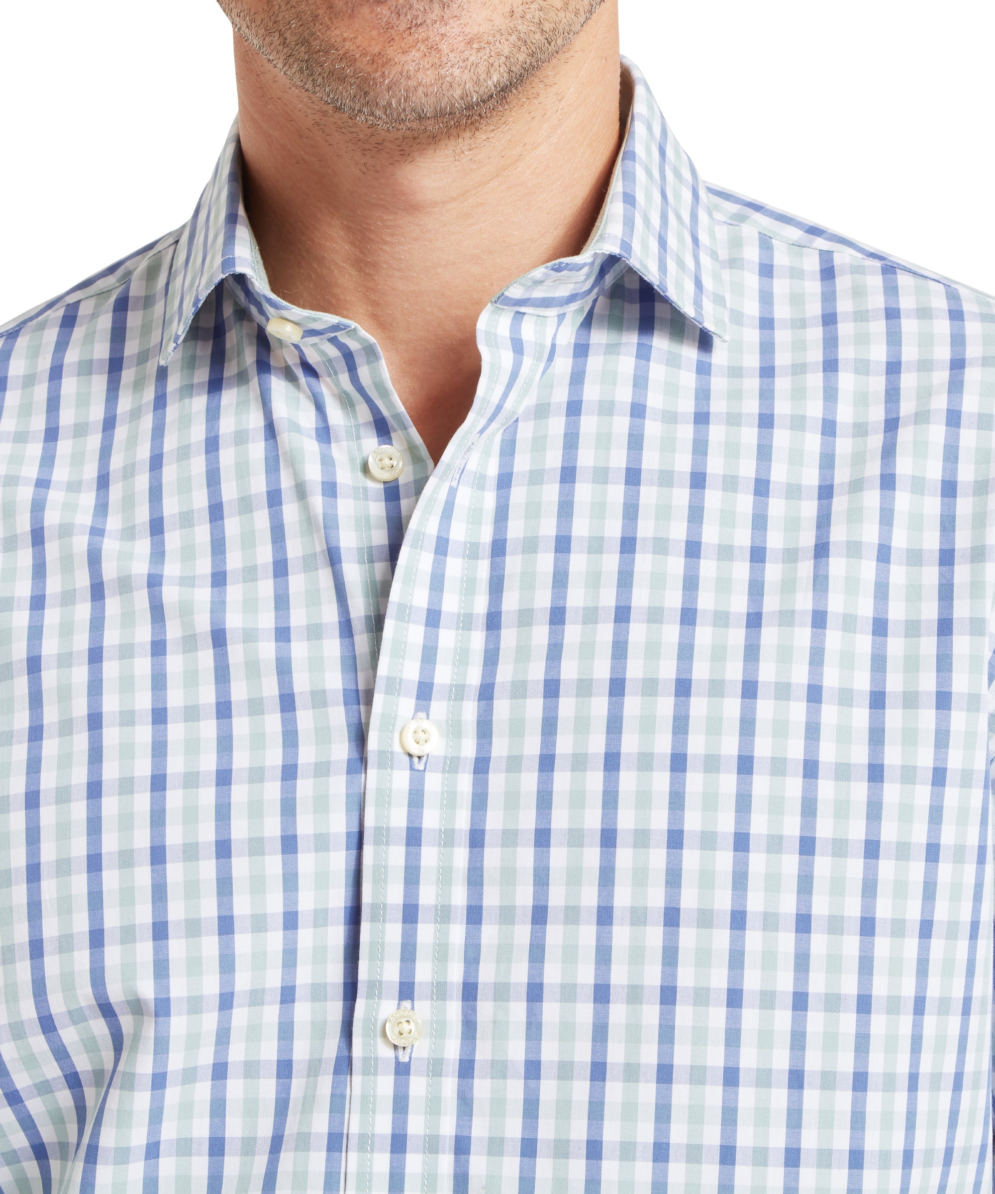 Man wearing a long-sleeved, button-up shirt with a check pattern in light blue, dark blue, and white. The shirt features a classic collar and white buttons down the front. The fabric appears lightweight and suitable for casual or semi-formal wear. The image focuses on the upper torso, highlighting the shirt’s pattern and fit.