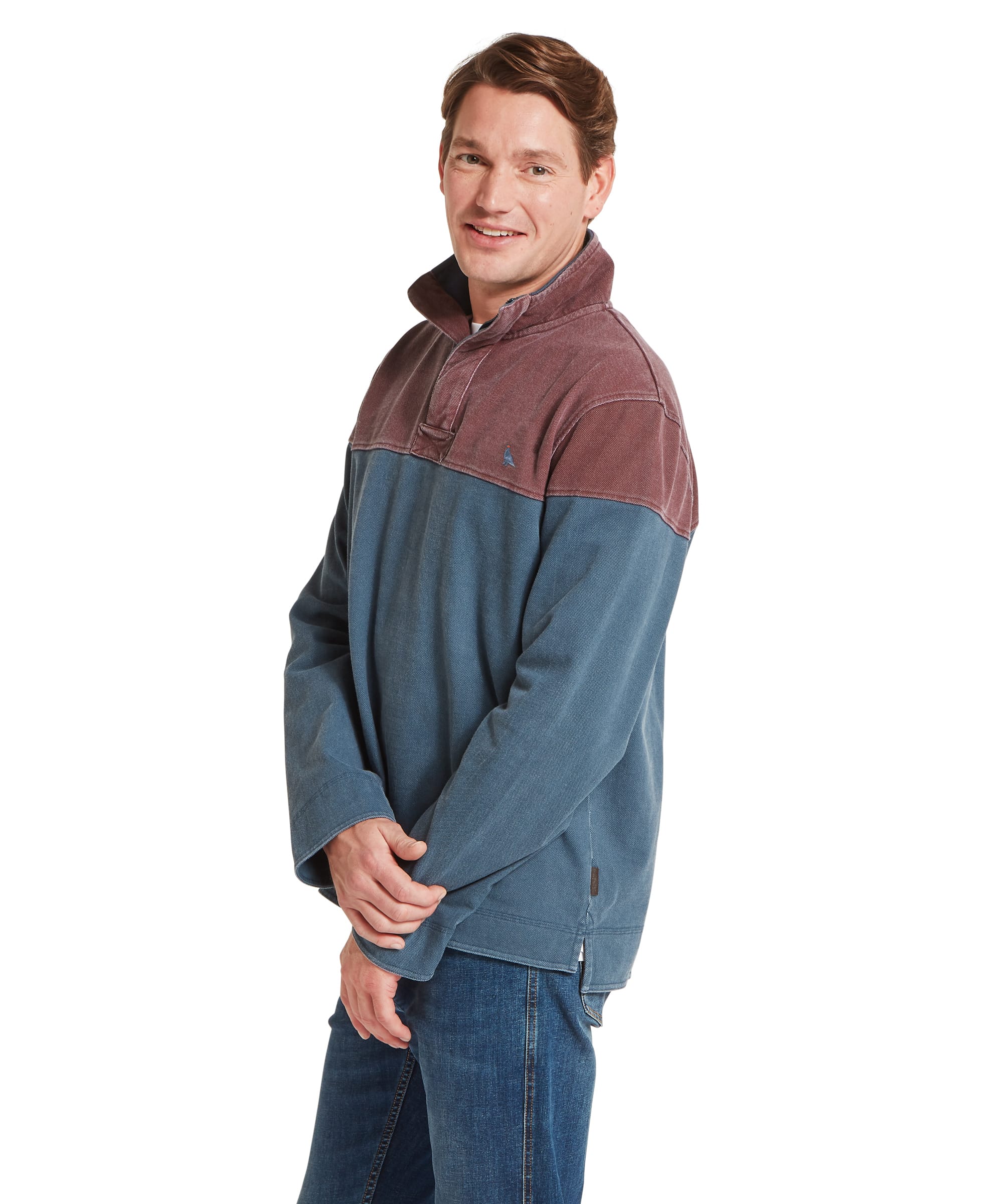 Schöffel Men's Helford Heritage Sweatshirt in red and petrol blue, side view showing colour block design with smiling male model, quarter-zip neck and Schöffel logo