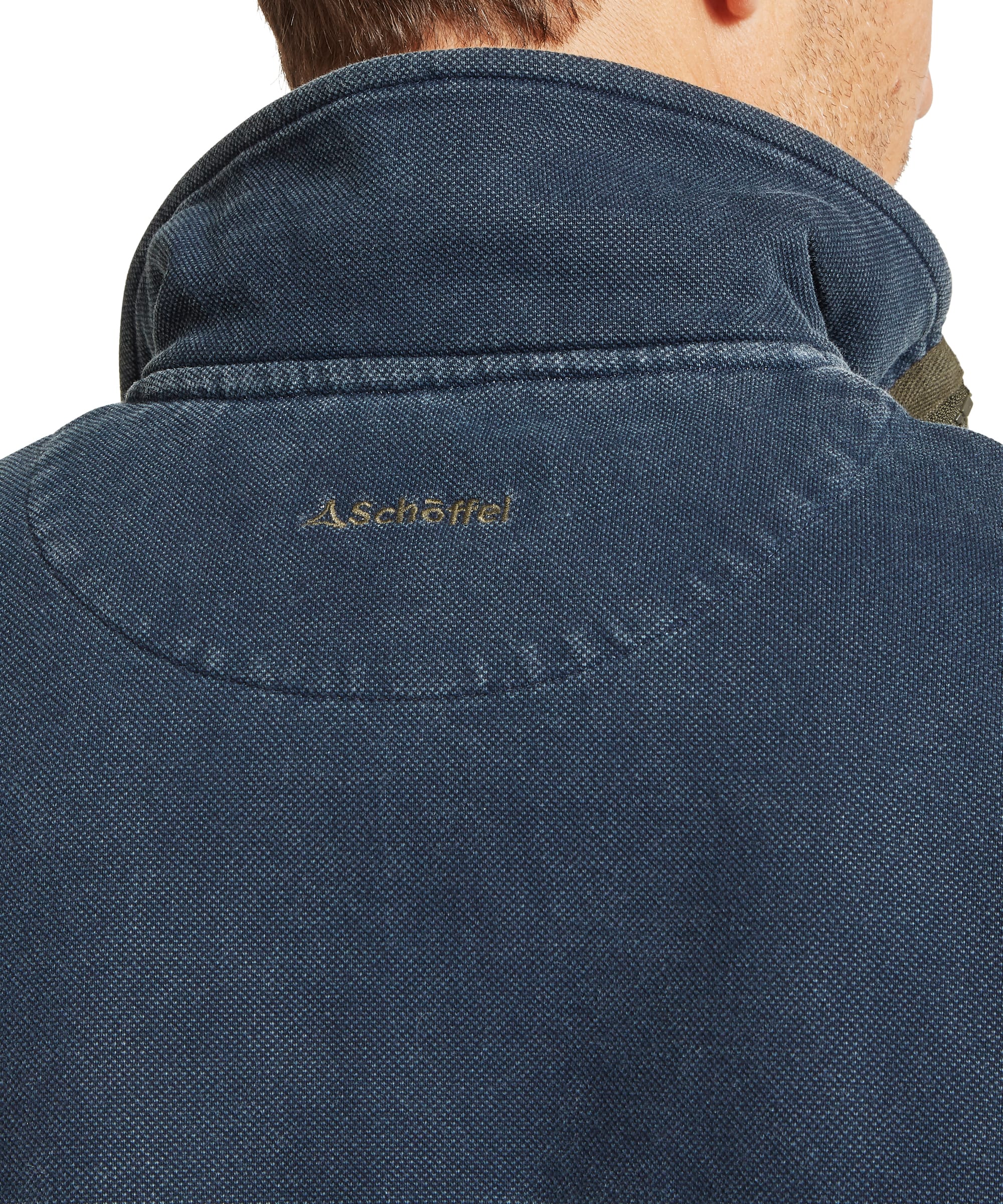 Close-up detail of back neck on Schöffel Men's Helford Heritage Sweatshirt in navy showing embroidered Schöffel logo on pigment-dyed cotton fabric