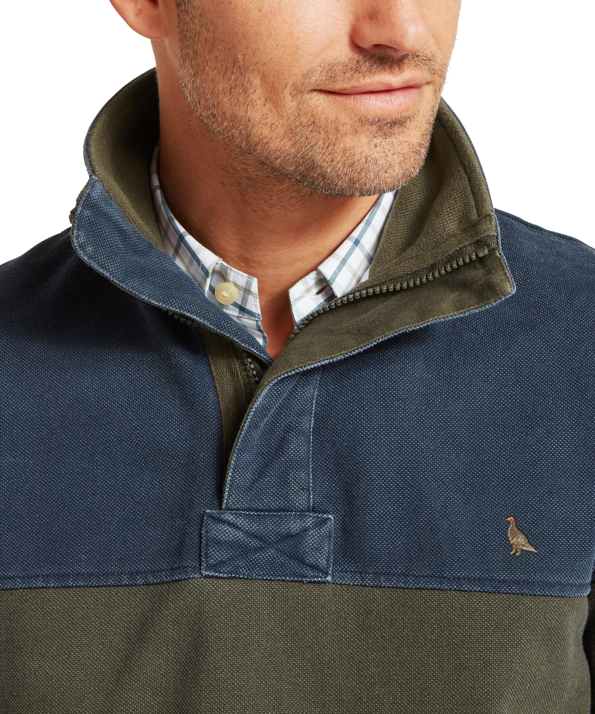 Close-up of Schöffel Men's Helford Heritage Sweatshirt in green and navy showing quarter-zip collar detail, woven placket and embroidered pheasant logo on chest