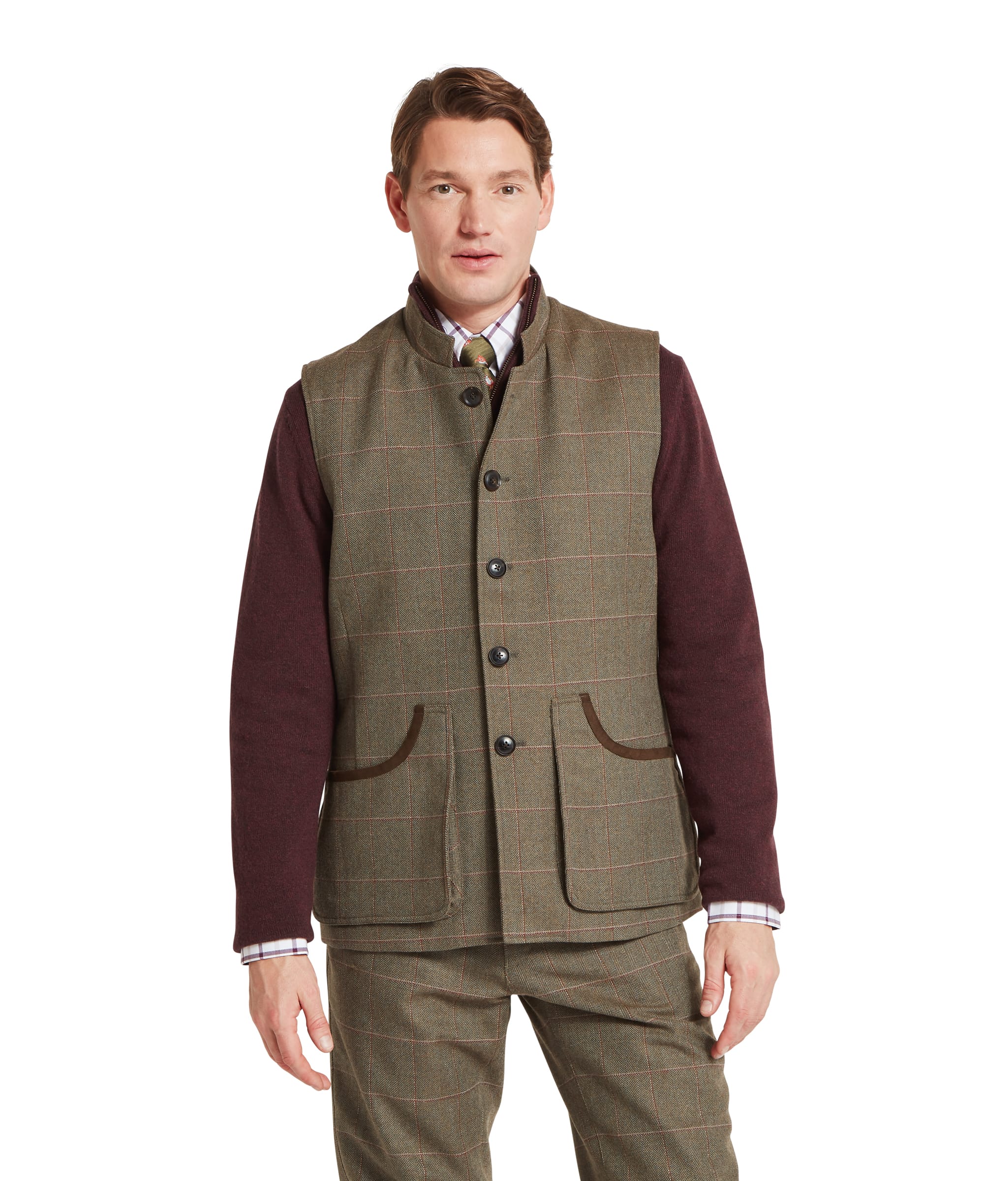 Schöffel Men's Holcot Tweed Waistcoat in Lochlane Tweed, front view worn over burgundy knitwear with check shirt and tie, showing button front and large patch pockets with suede trim