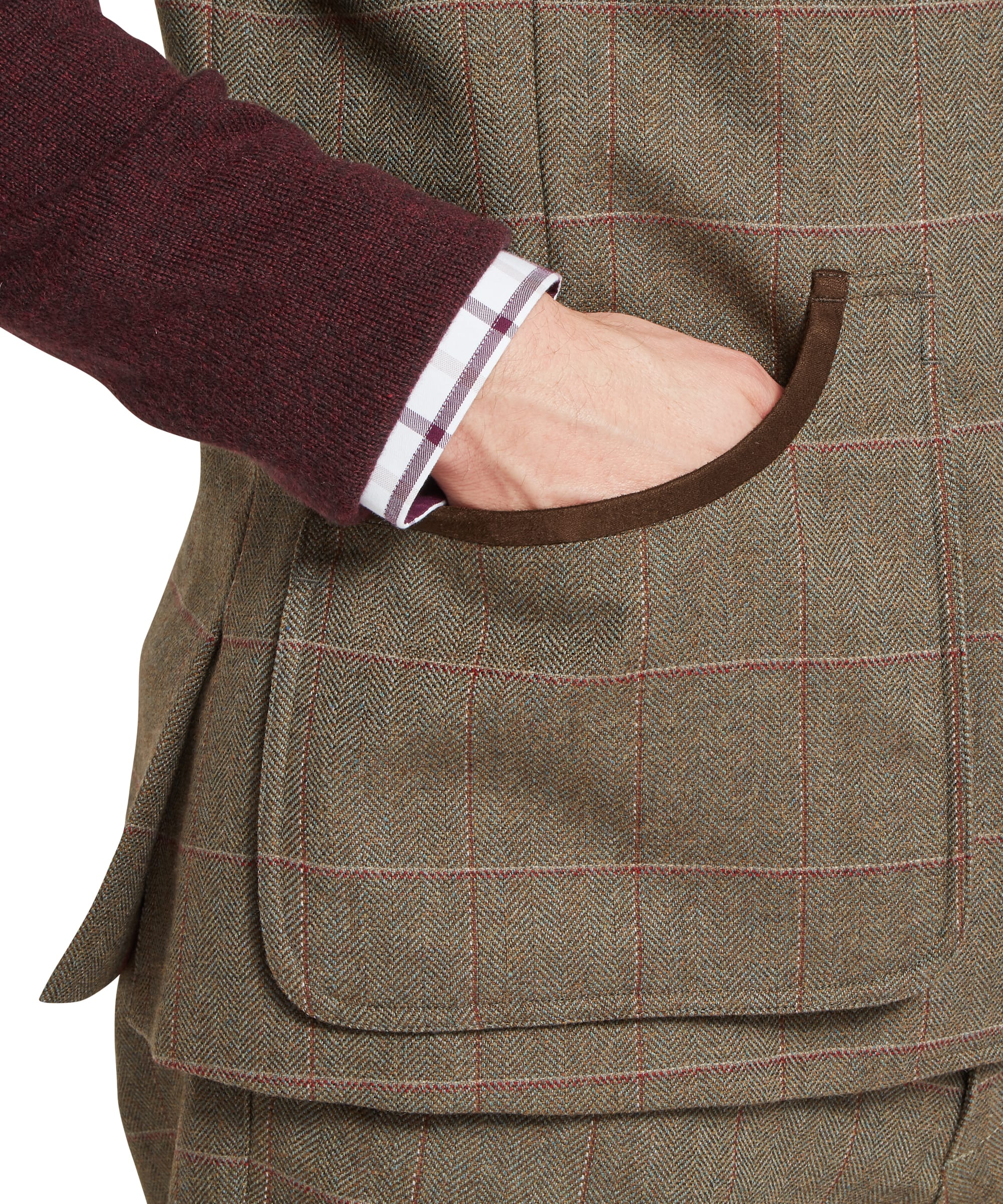 Close-up detail of Schöffel Men's Holcot Tweed Waistcoat pocket in Lochlane Tweed showing herringbone weave, windowpane overcheck and contrasting suede leather pocket trim