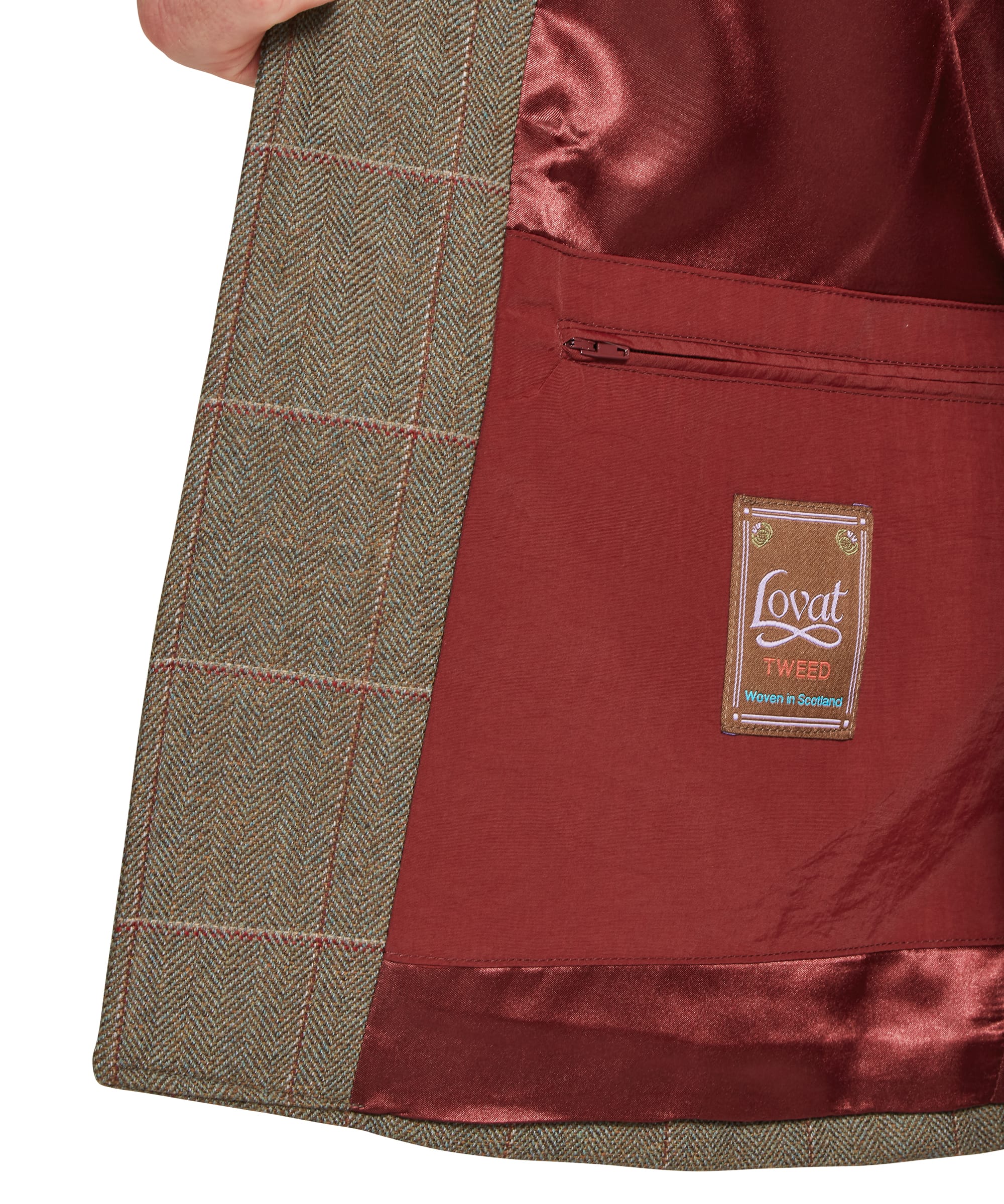 Interior detail of Schöffel Men's Holcot Tweed Waistcoat in Lochlane Tweed showing deep red satin lining, internal zip security pocket and Lovat Tweed Woven in Scotland label