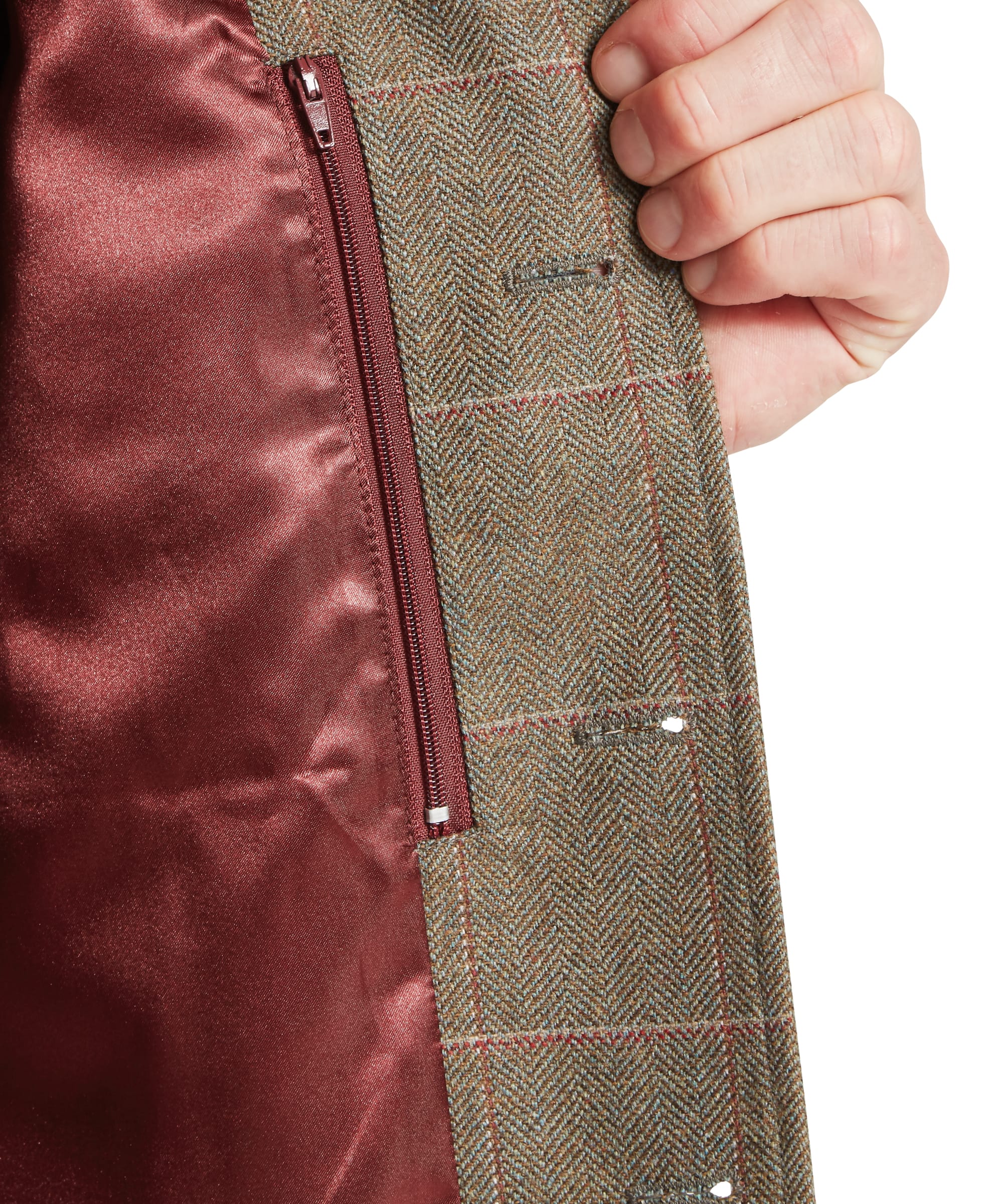 Close-up interior detail of Schöffel Men's Holcot Tweed Waistcoat in Lochlane Tweed showing red satin lining, internal zip pocket and herringbone windowpane tweed outer fabric