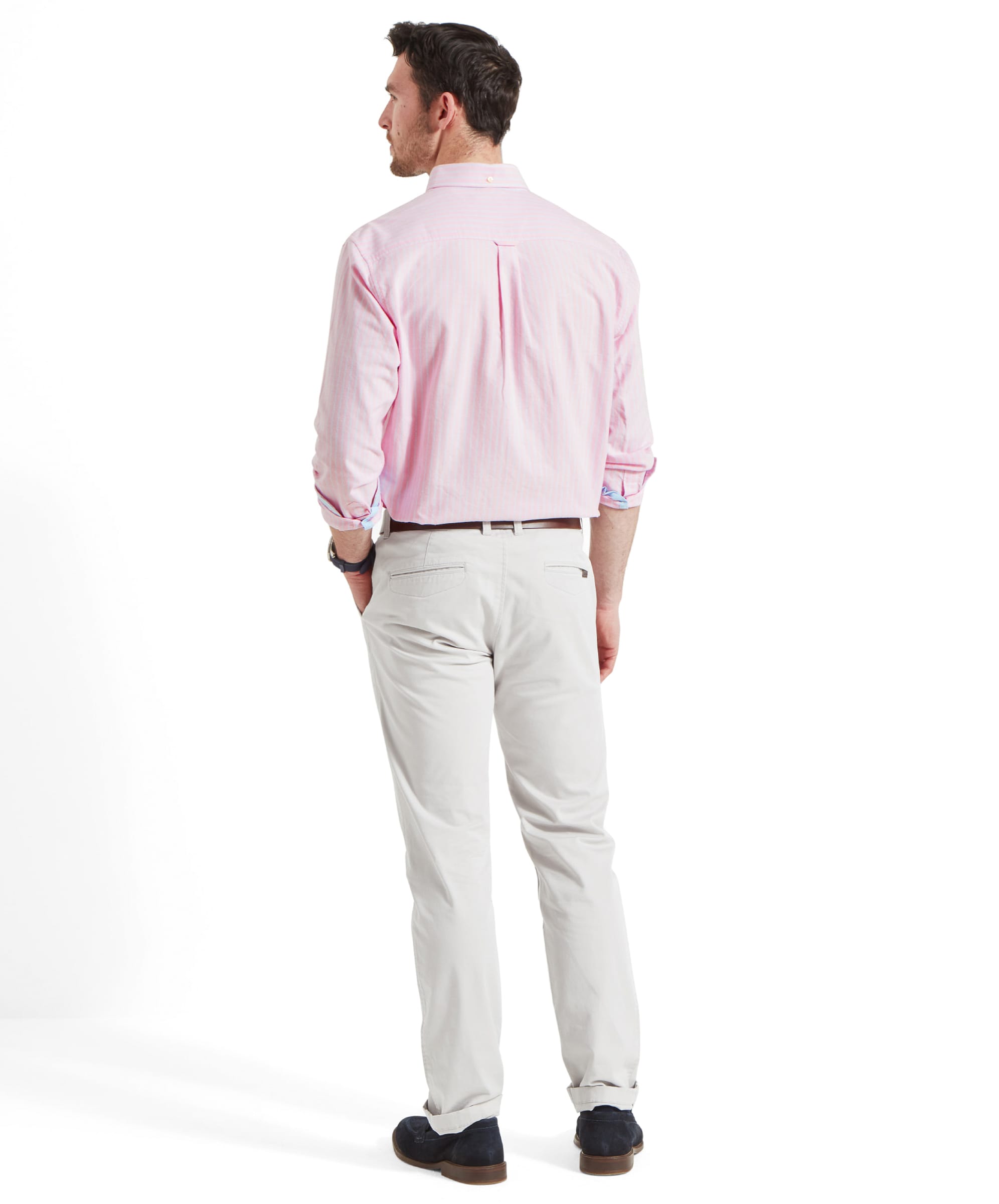 Back full view of a man wearing the Schöffel Holt Soft Oxford Tailored Shirt for Men in Pink Stripe. Highlighting the fit and the double pleat at the back, featuring the locker loop.