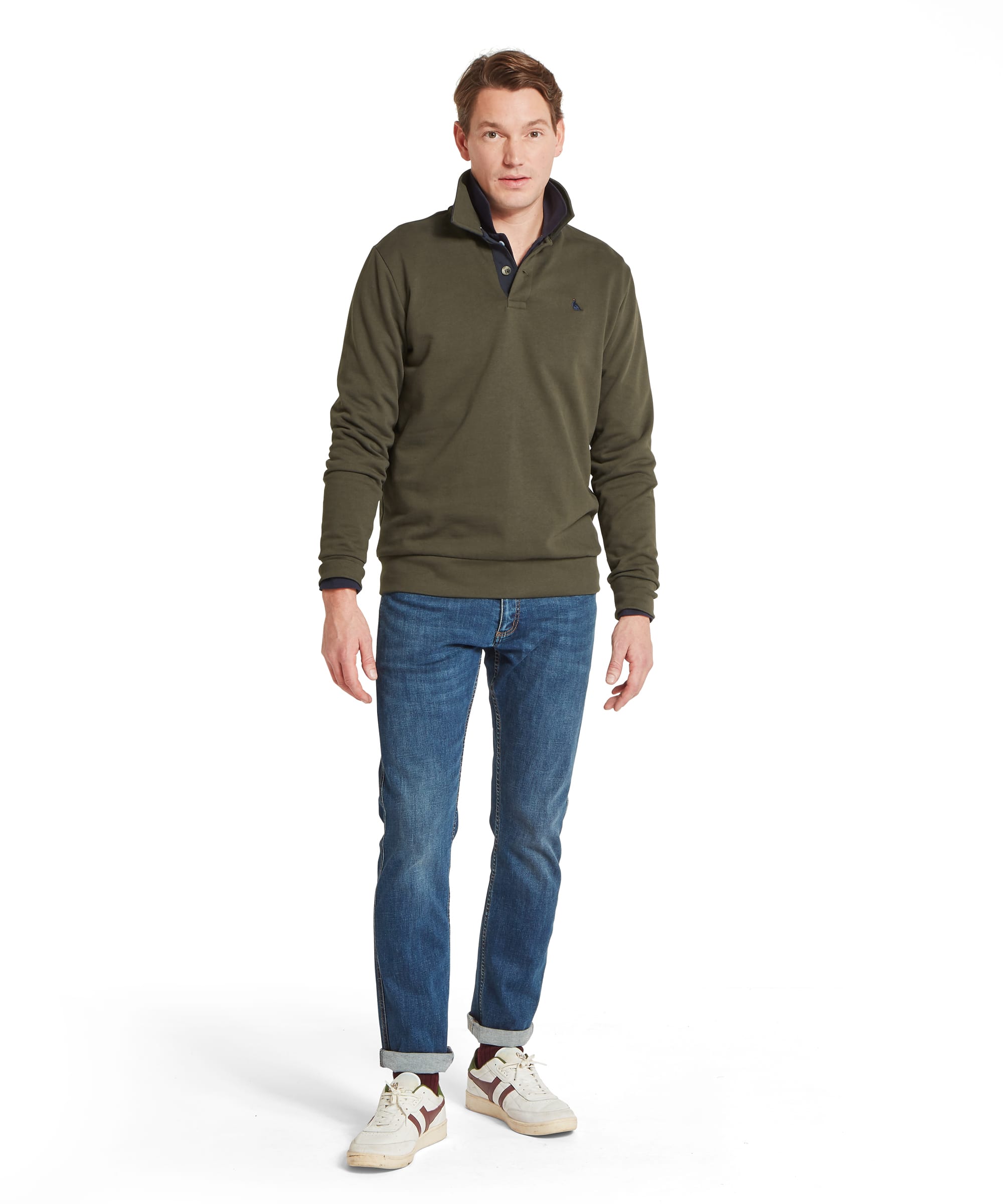 Schöffel Men's Horseley Rugby Sweatshirt in green worn with blue jeans and white trainers, full length front view showing relaxed country casual styling