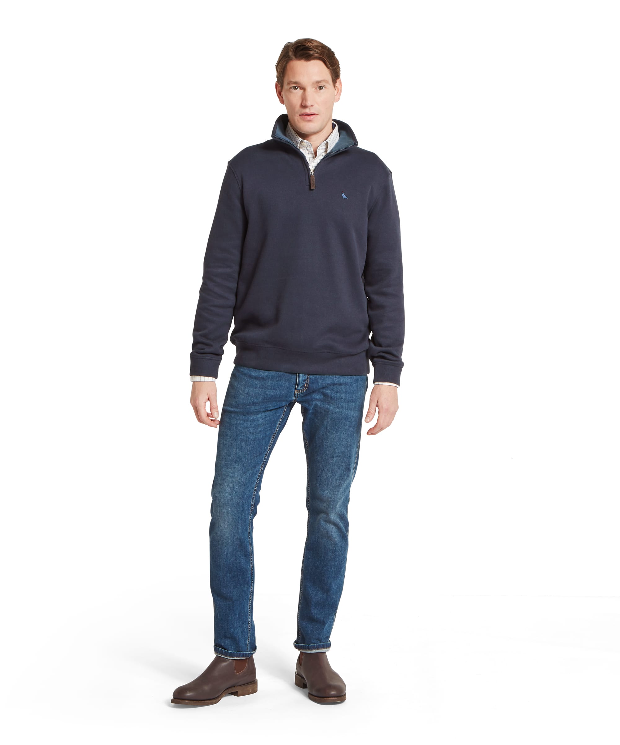 Schöffel Men's Kingsand Quarter-Zip Jumper in navy worn with blue jeans and brown leather Chelsea boots, full length front view showing smart country casual outfit
