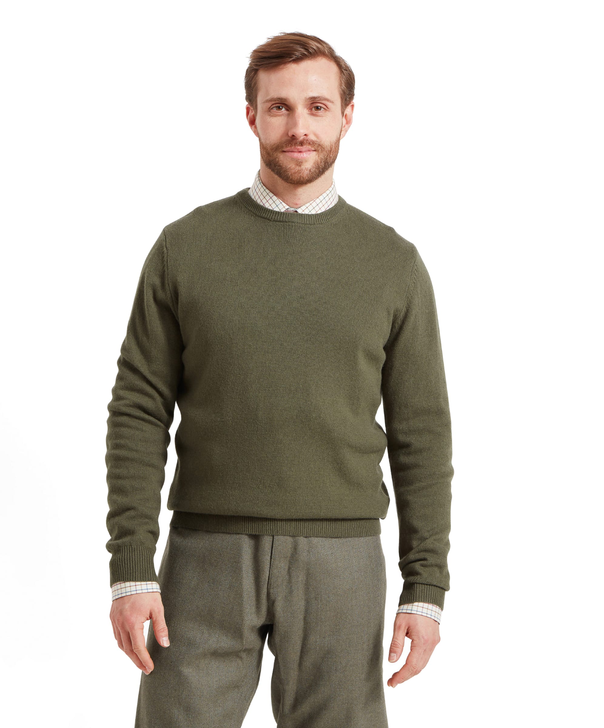 Man wearing a green jumper and trousers on a white background