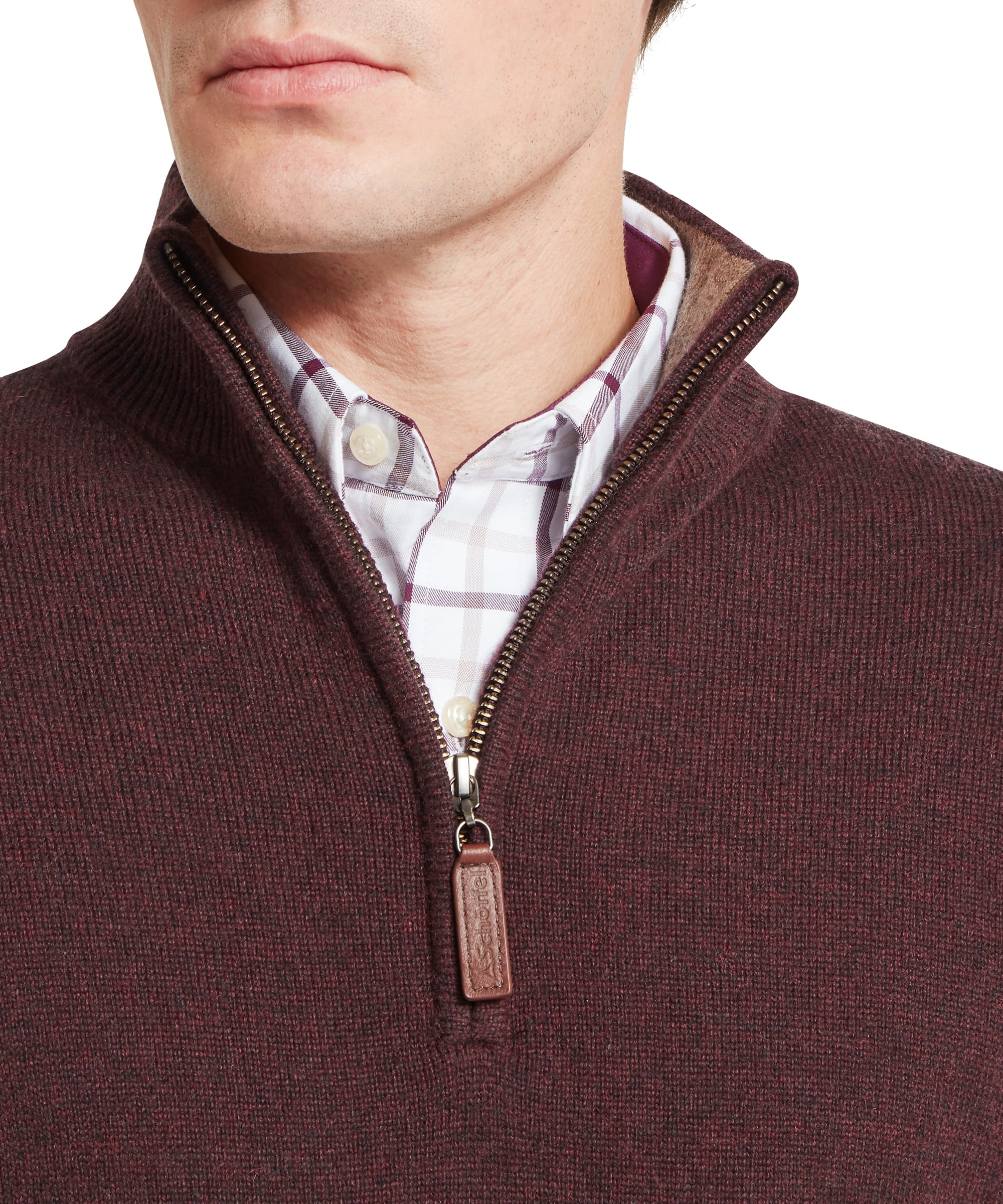 Close-up of Schoffel Mens Lewis Lambswool Quarter-Zip Jumper in burgundy showing quarter-zip neck detail with contrast suede inner collar and Schoffel branded leather zip pull, worn over a check shirt