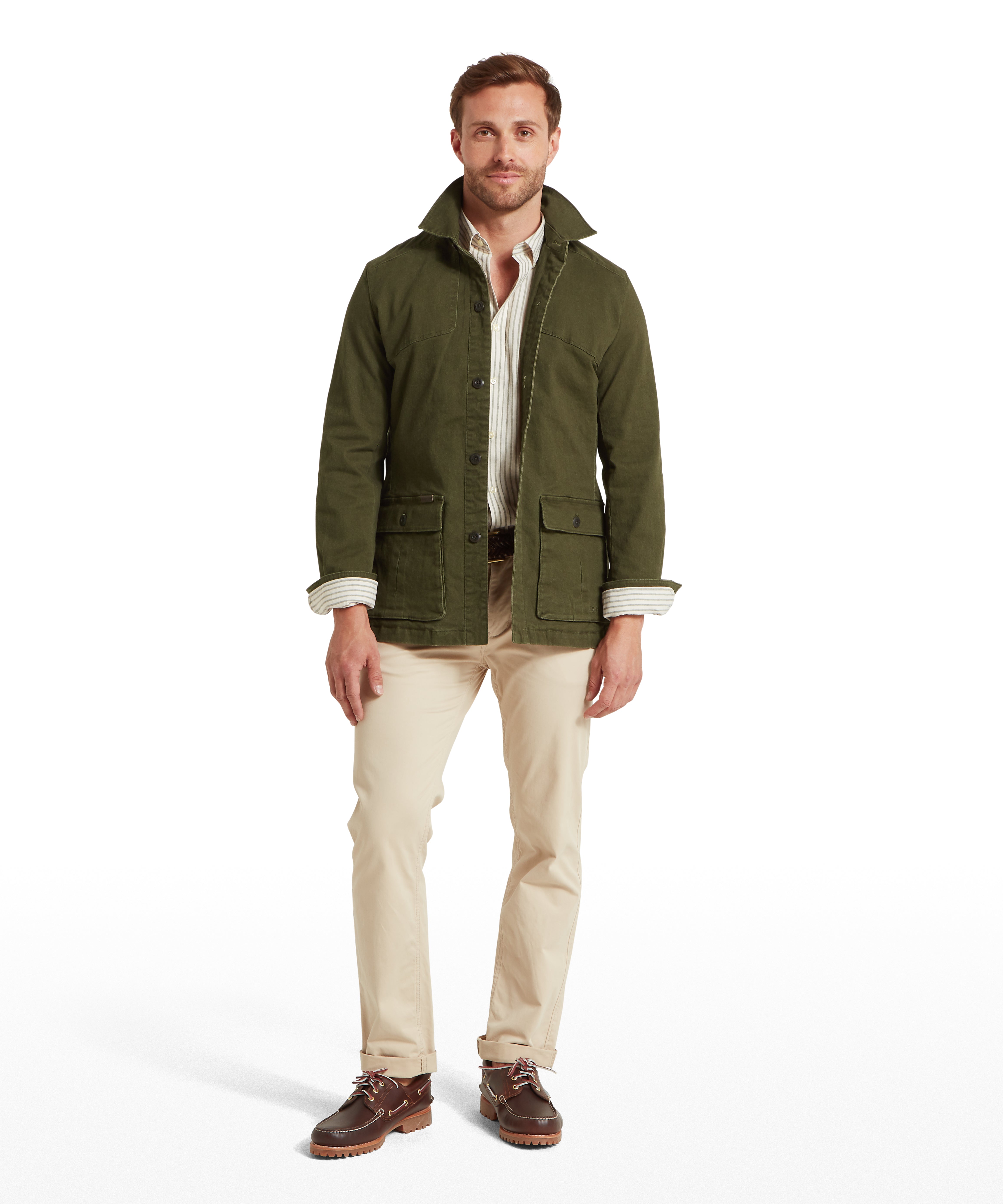 Man wearing a green jacket, white striped shirt, beige trousers, and brown shoes on a white background