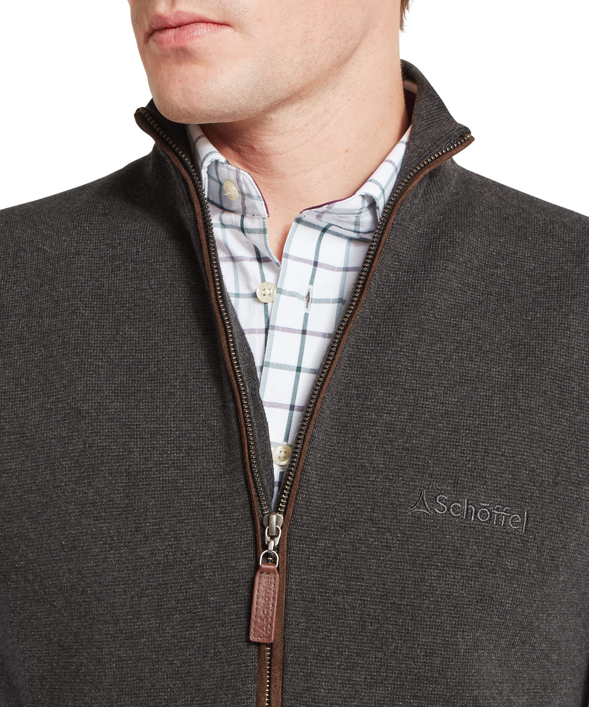 Close-up of Schoffel Mens Marlow Gilet in charcoal showing full-length zip neck detail with contrast tan leather Schoffel zip pull, tone-on-tone Schoffel logo embroidery and check shirt layering