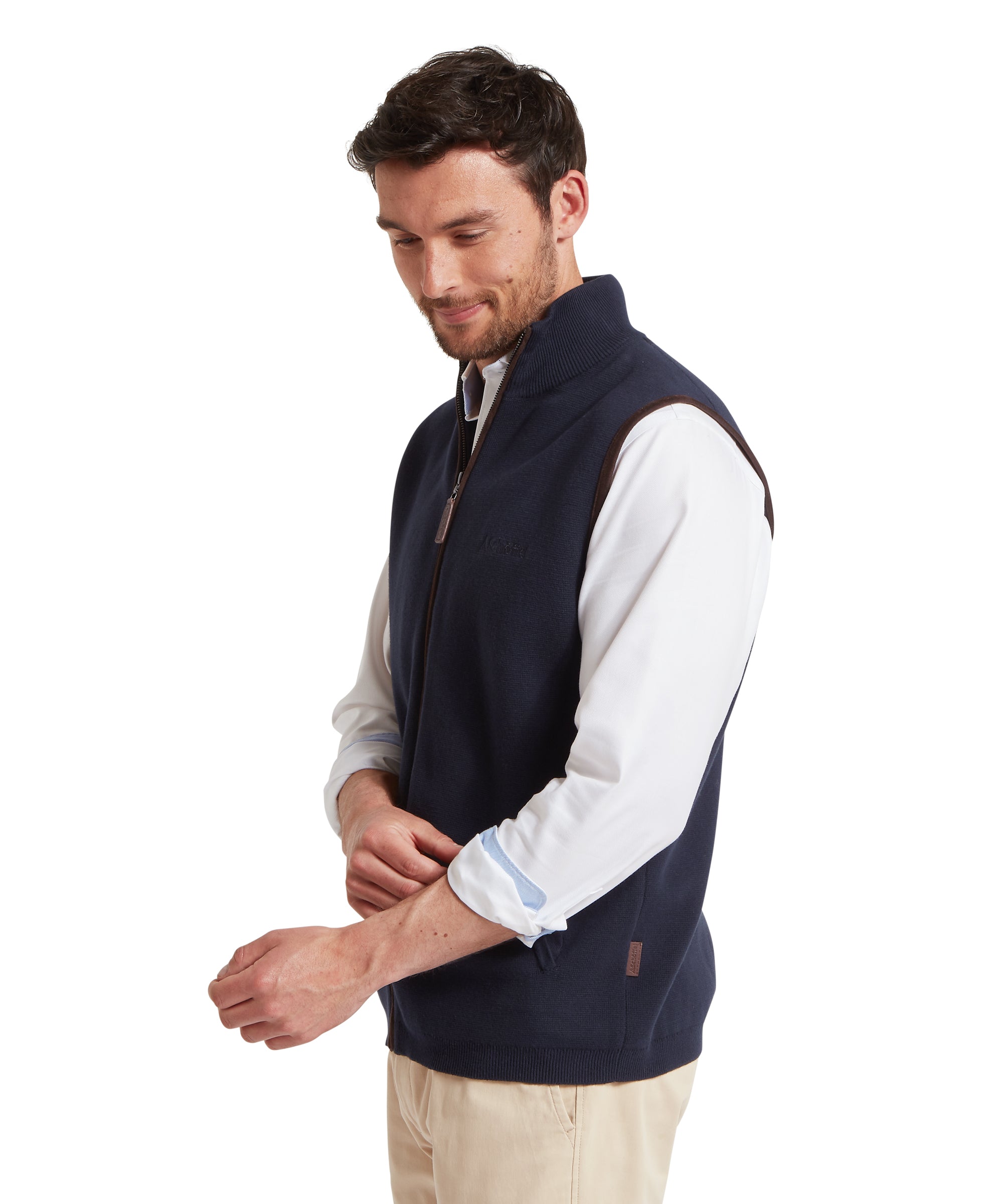 Man wearing a navy gilet over a white shirt on a white background