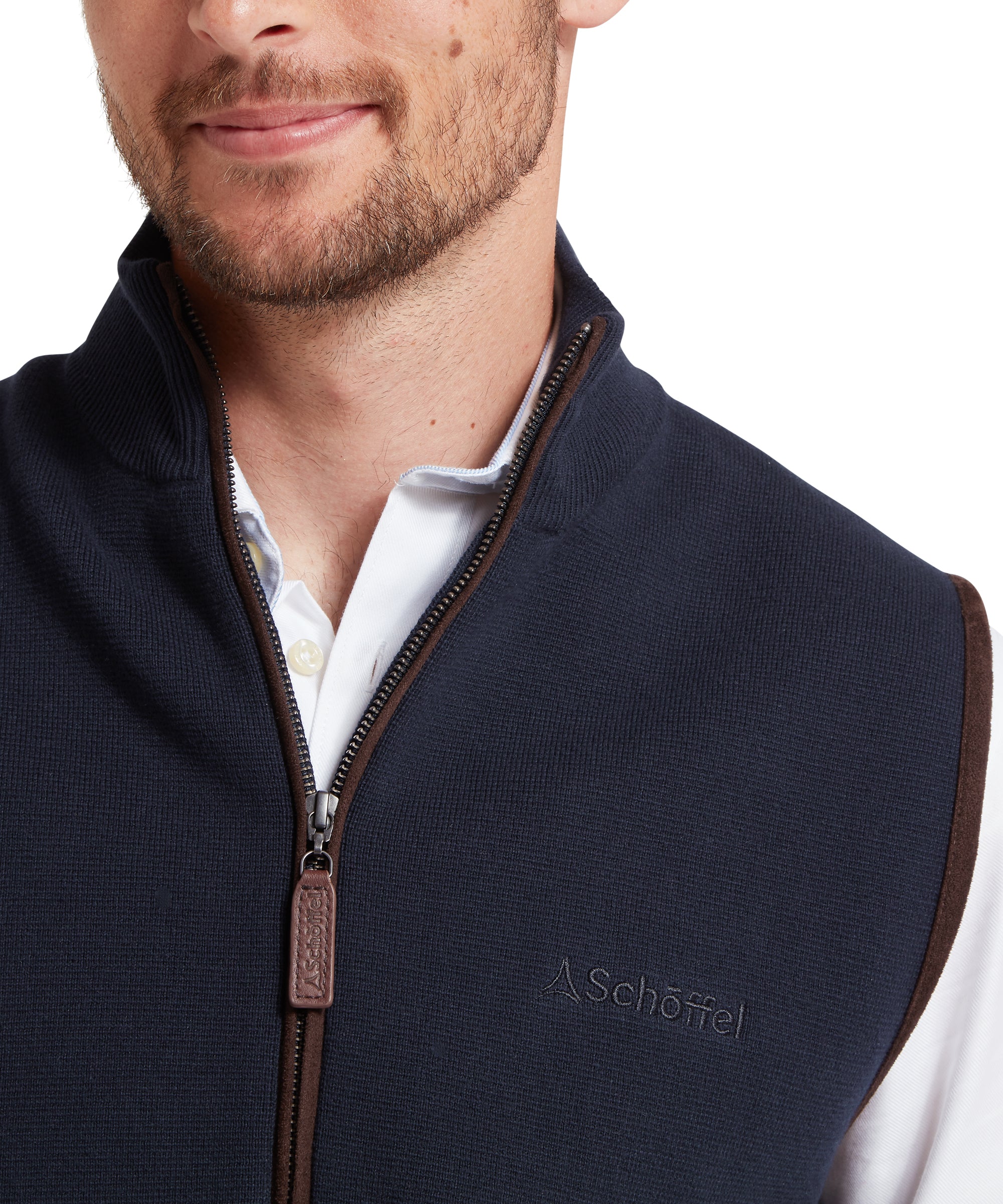 Man wearing a navy blue gilet with a zipper, featuring the Schöffel logo.