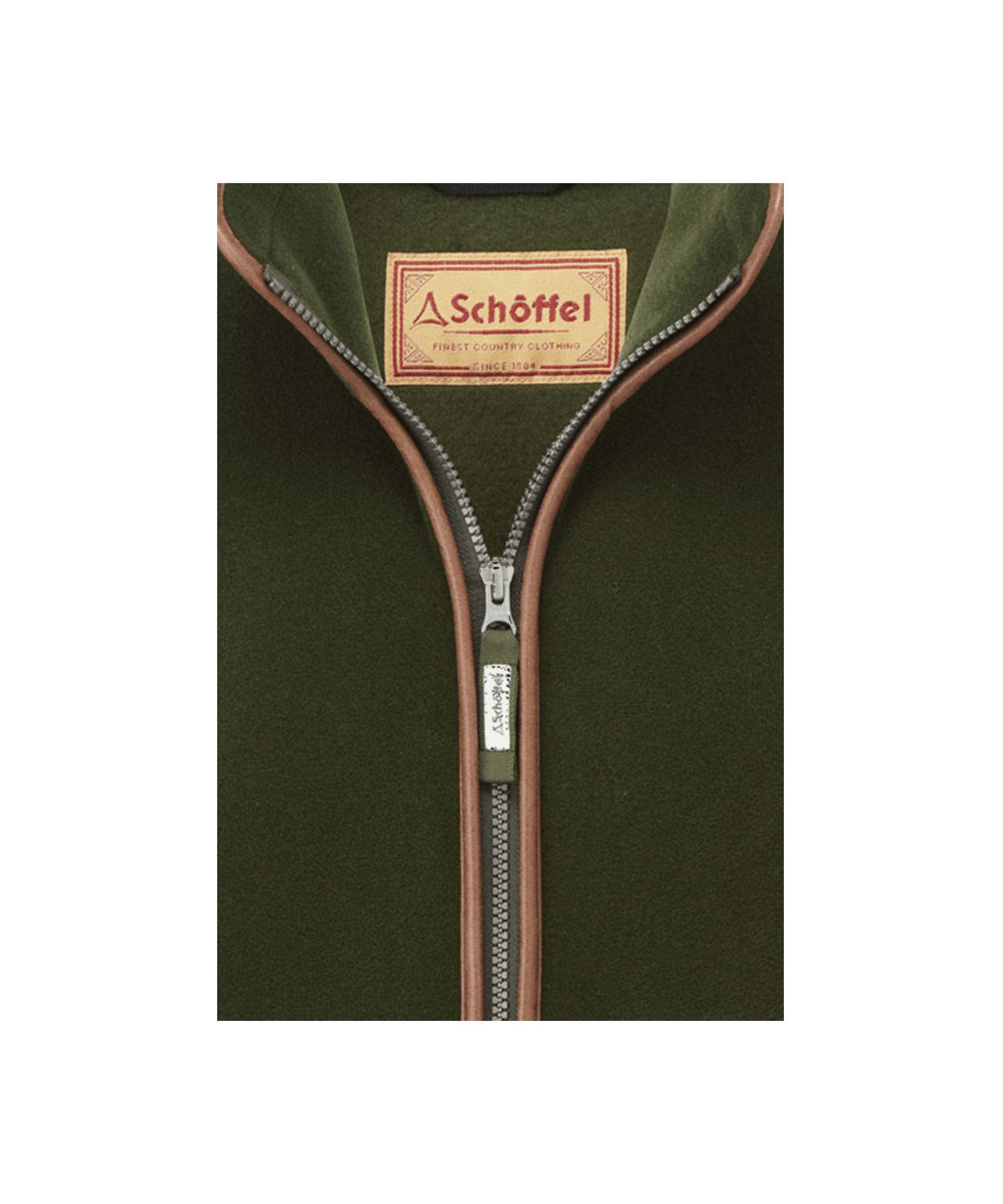 Schöffel Men's Oakham Fleece Gilet in Green close-up showing full-zip opening with leather trim and branded heritage label detail