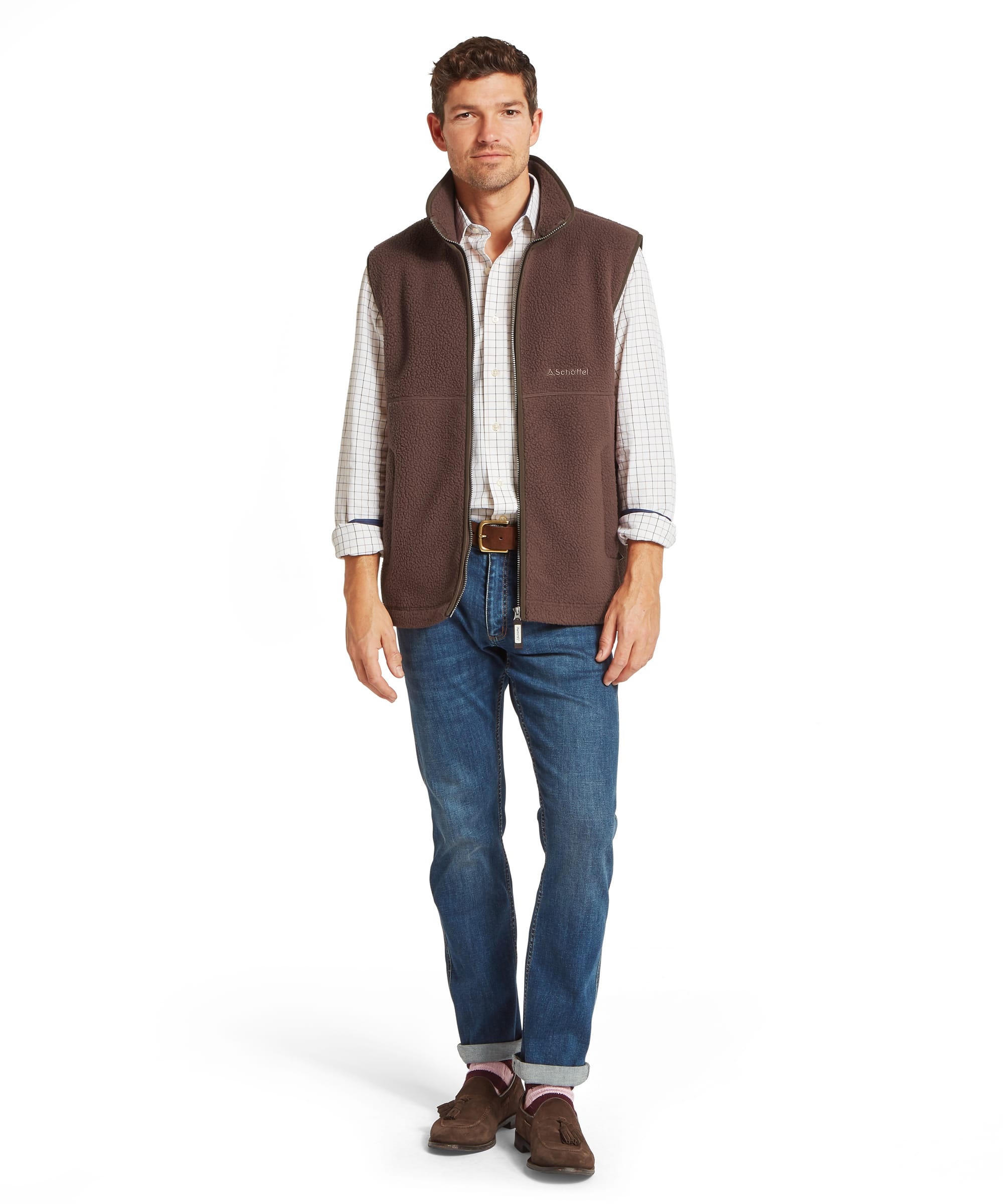 Schoffel Mens Oakham Retro Fleece Gilet in dark brown worn with blue jeans, check shirt and brown suede tassel loafers, full length front view showing sherpa fleece texture and country casual styling
